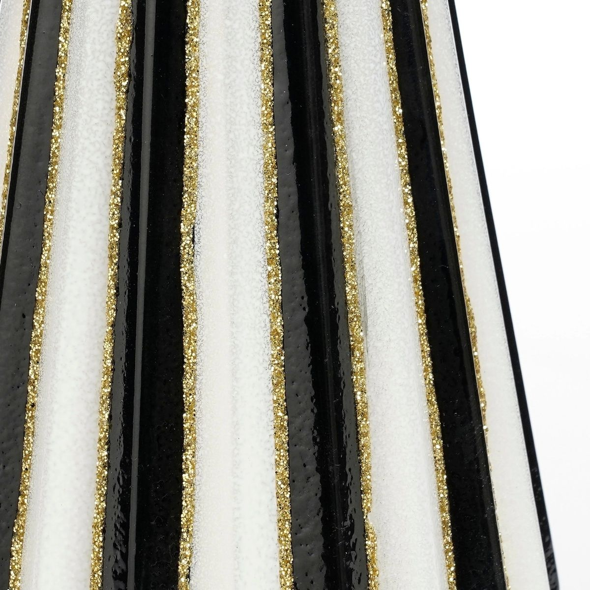 Black, white, and gold stripes on a textured surface.