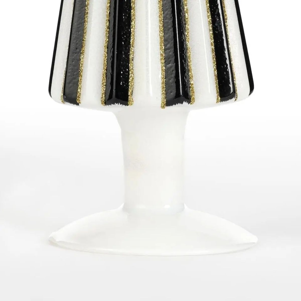 A white candle holder with black and gold stripes.