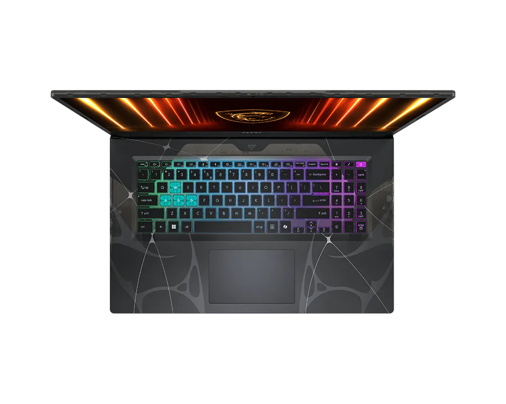 Vista dall'alto di un laptop aperto con tastiera RGB colorata e schermo luminoso.
