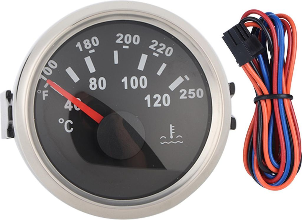 Ein schwarzer Thermometer mit silbernem Rand und roten Zeiger, daneben bunte Kabel.