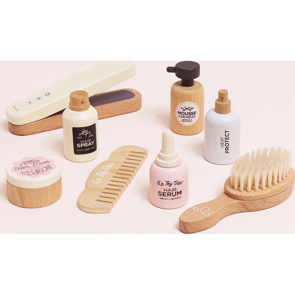 Articoli per capelli giocattolo in legno: piastra, pettine, spazzola, flaconi spray.