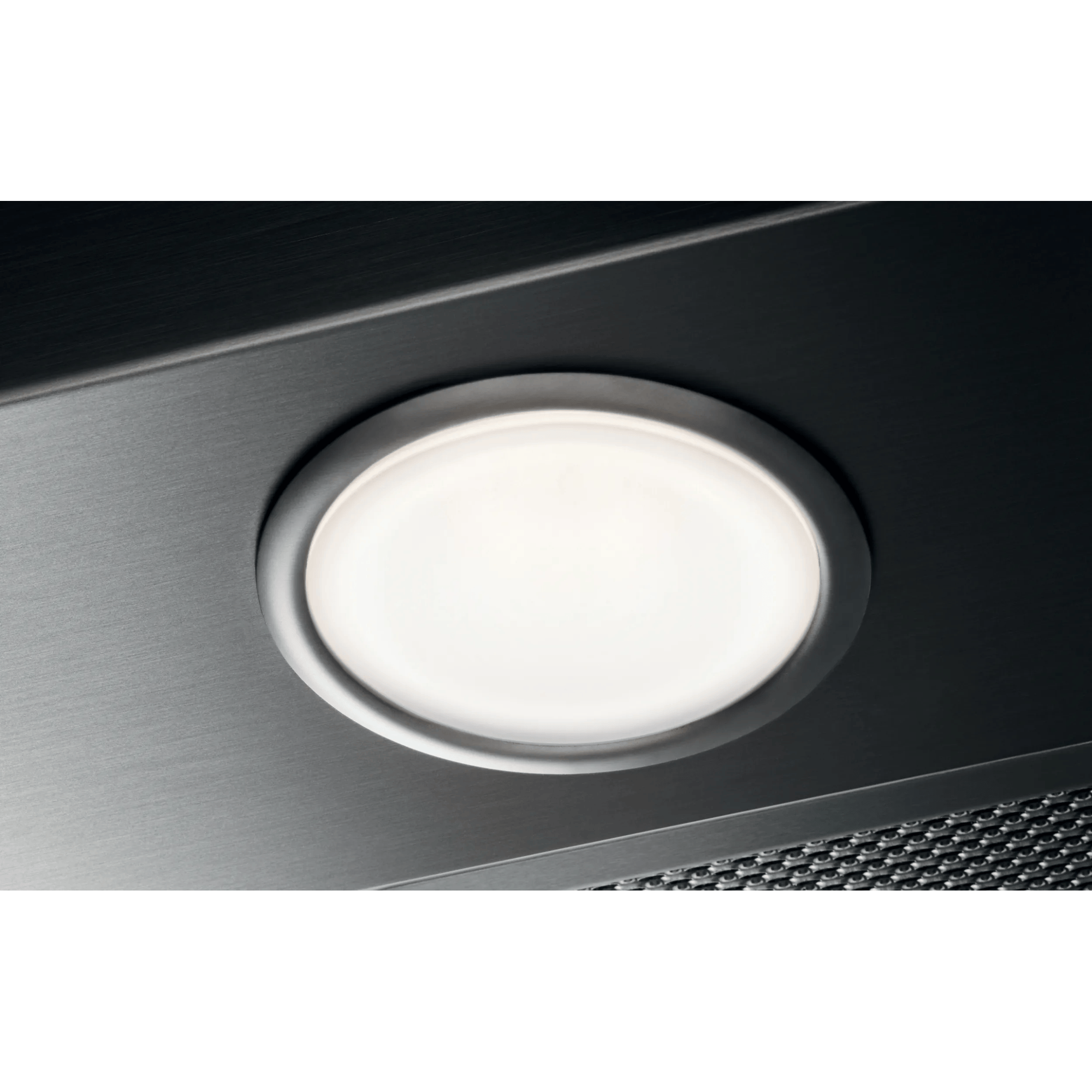 Una luz redonda y brillante sobre una superficie de metal cepillado.