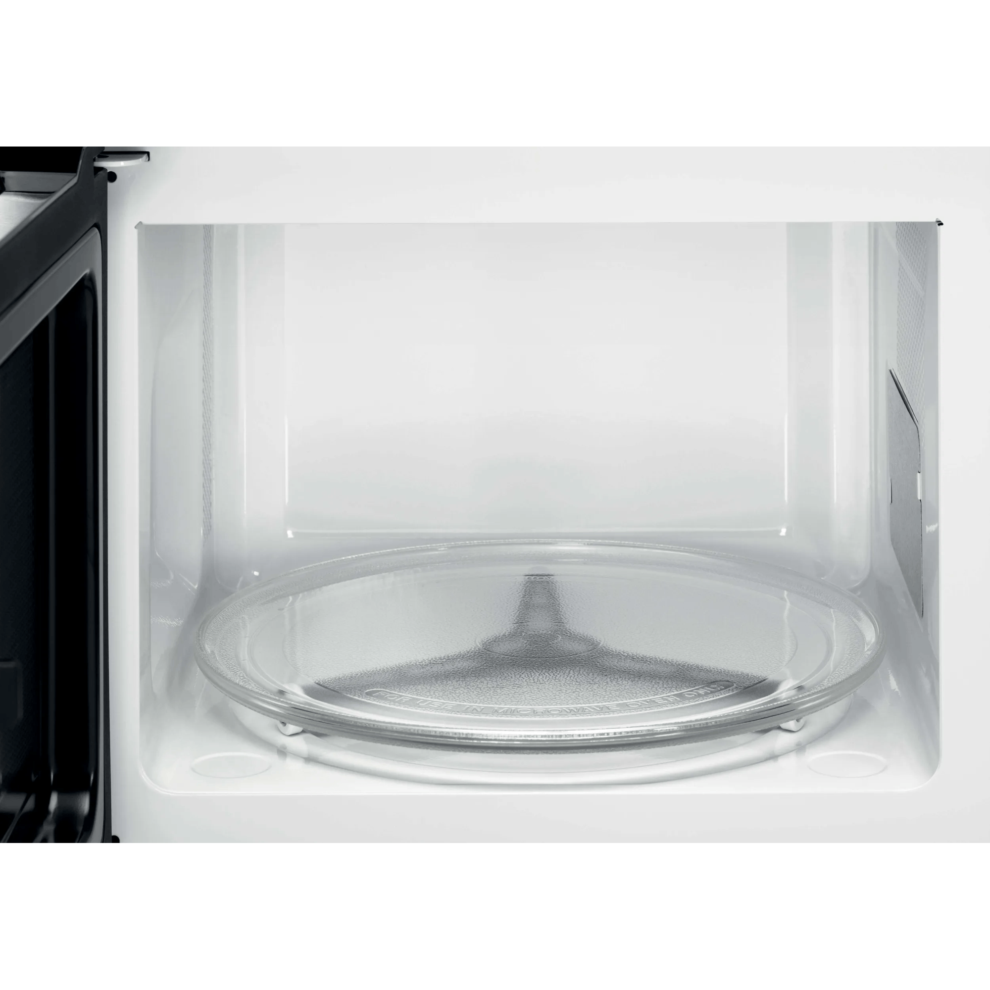 Interno di un forno a microonde con piatto girevole in vetro.