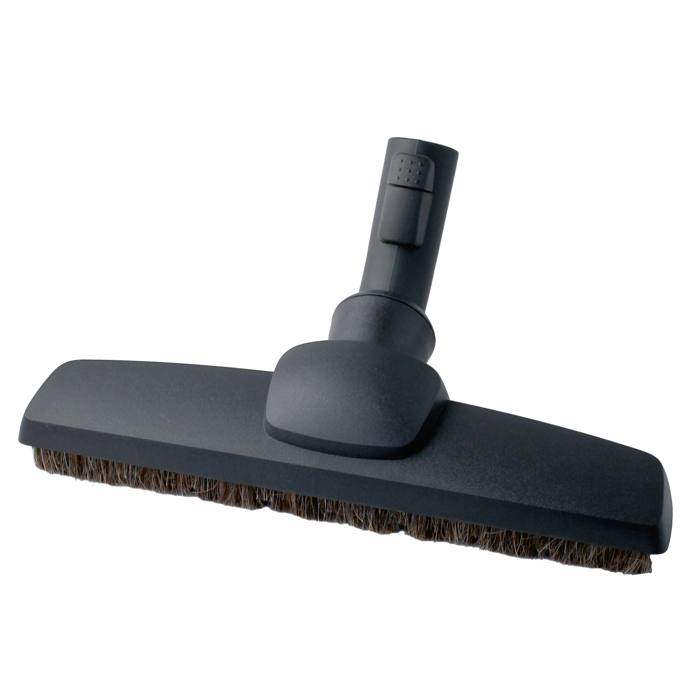 Une buse d'aspirateur sombre avec des poils.