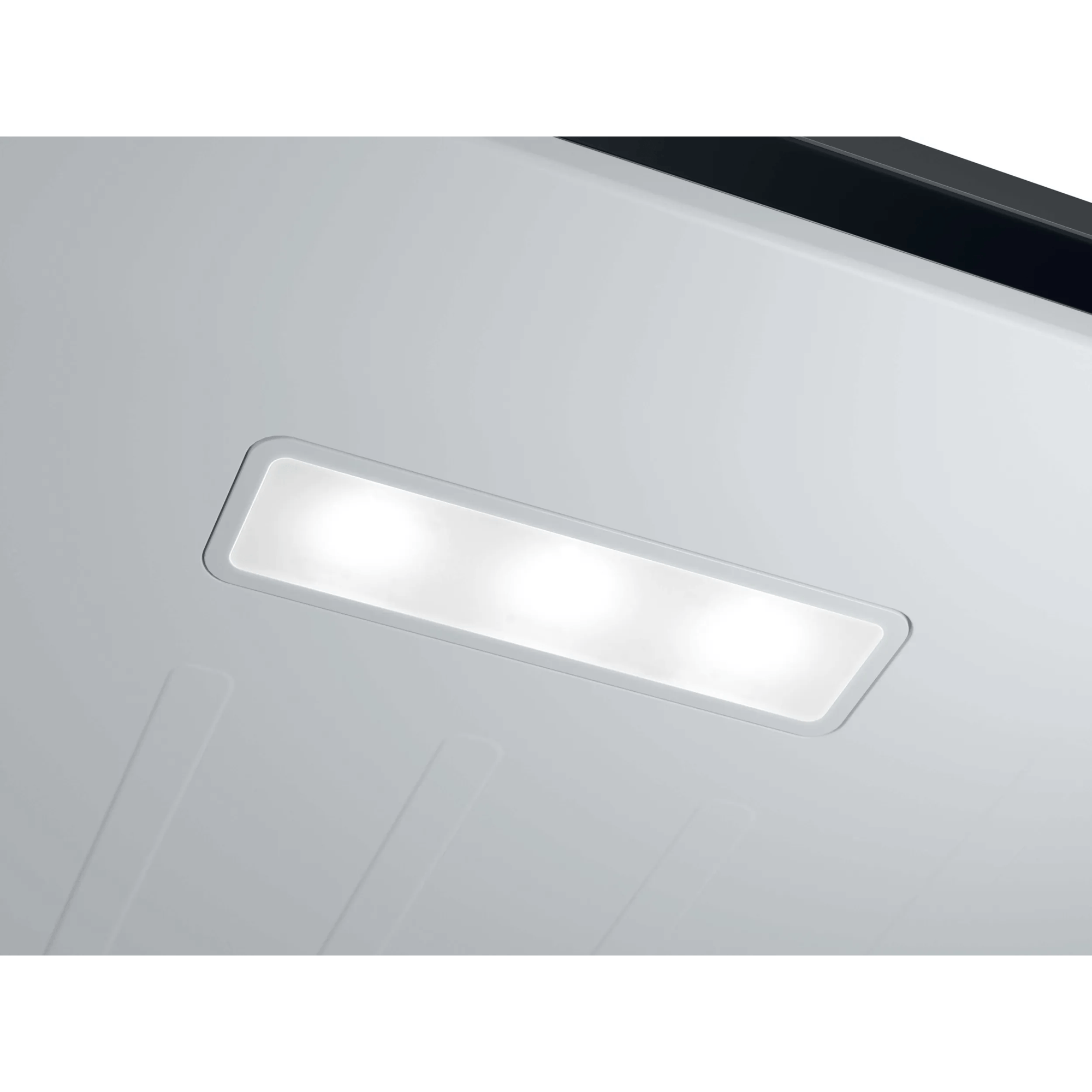 Un panel de luz rectangular con tres luces sobre una superficie blanca.