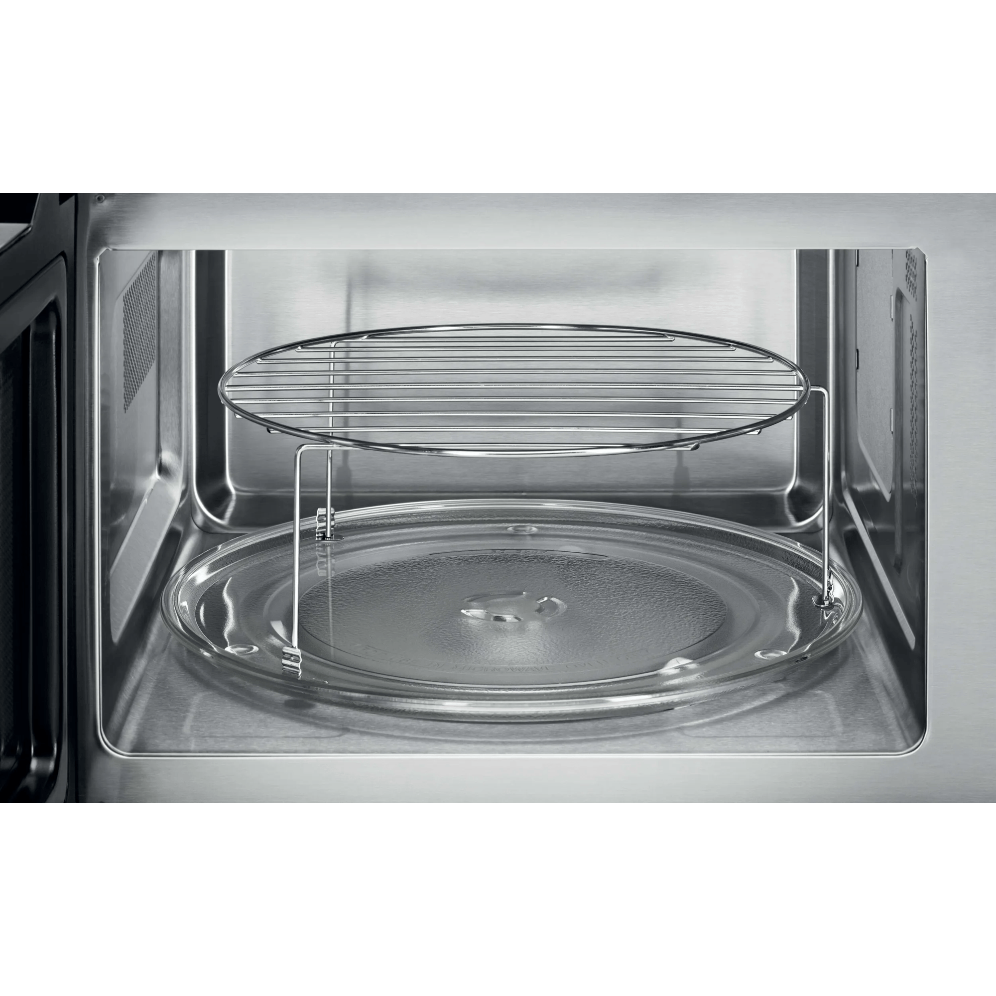 Interno microonde con piatto girevole in vetro e griglia.