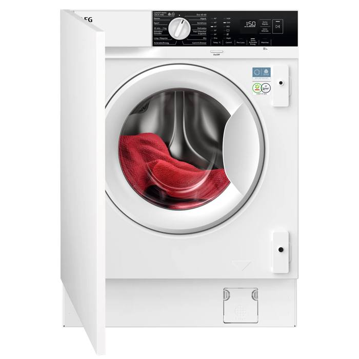 Una lavadora blanca con la puerta abierta, mostrando tela roja dentro.