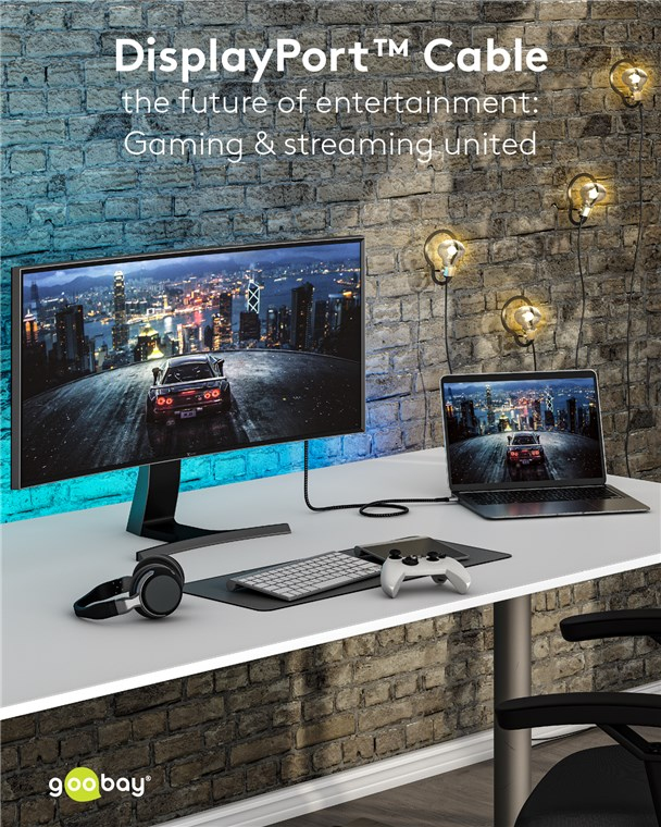 Ein Schreibtisch mit Monitor, Laptop, Tastatur, Kopfhörern und Controller.