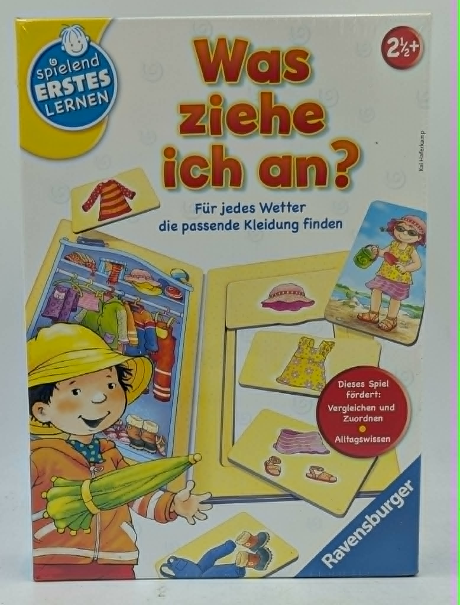 Brettspiel-Box mit Illustration eines Kindes, das Kleidung für verschiedene Wetterlagen auswählt.