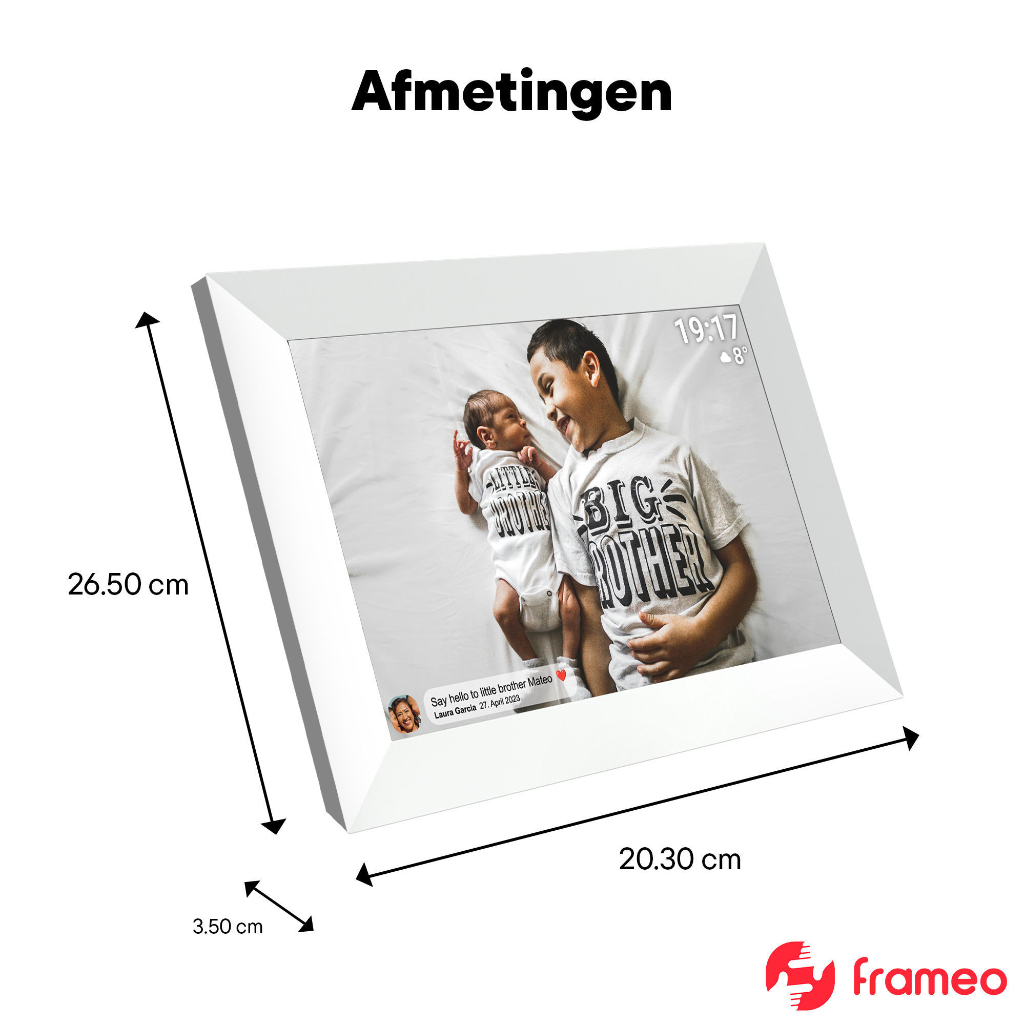 A digital photo frame displays two brothers, an infant and a boy, lying on a bed.