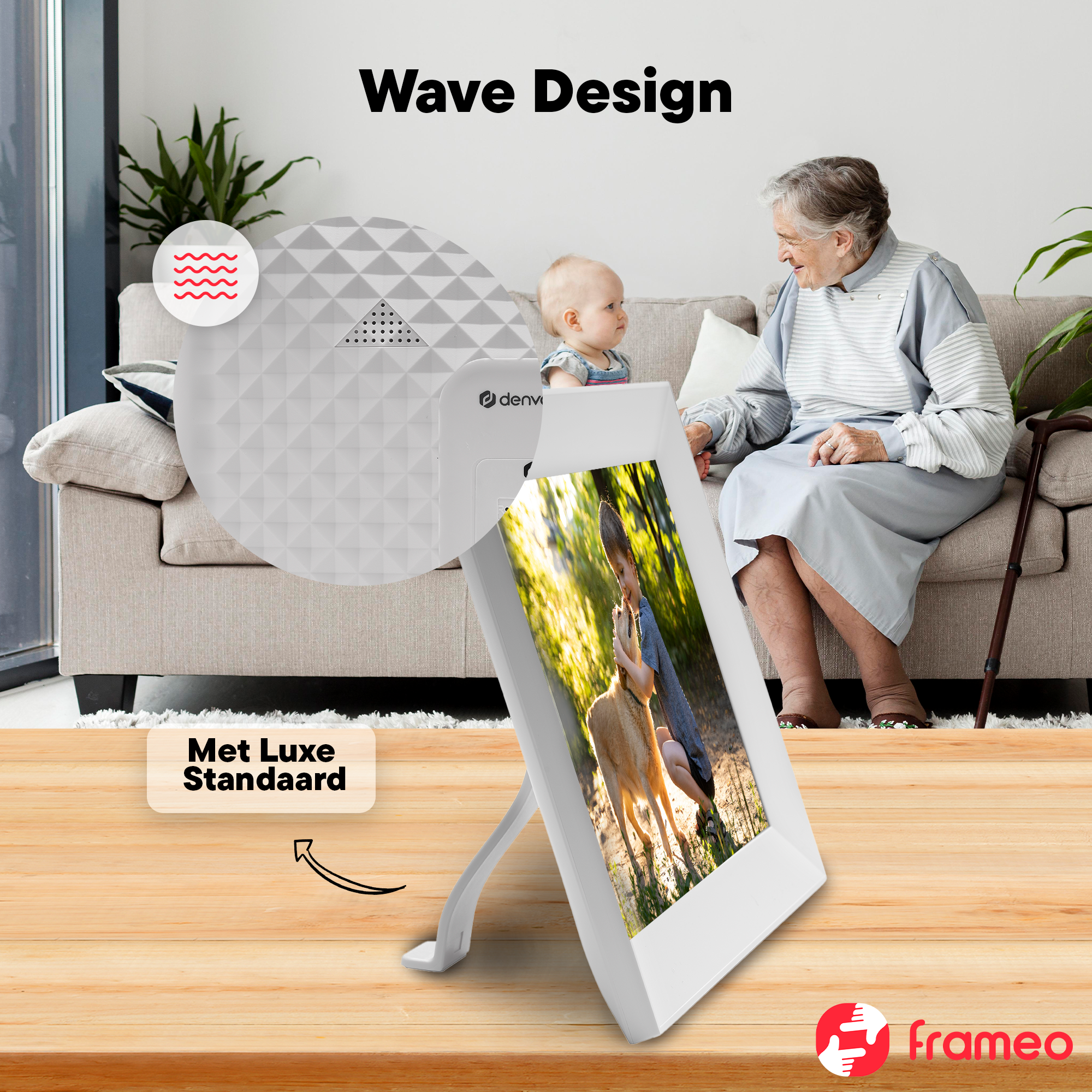 A baby and an elderly woman sit on a sofa. A digital frame shows a child with a dog.