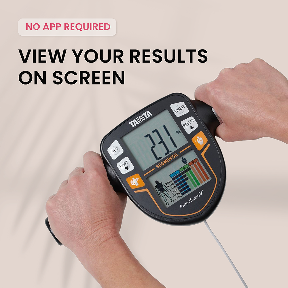 Tanita body composition analyzer showing 23.1%. Hands holding the device.