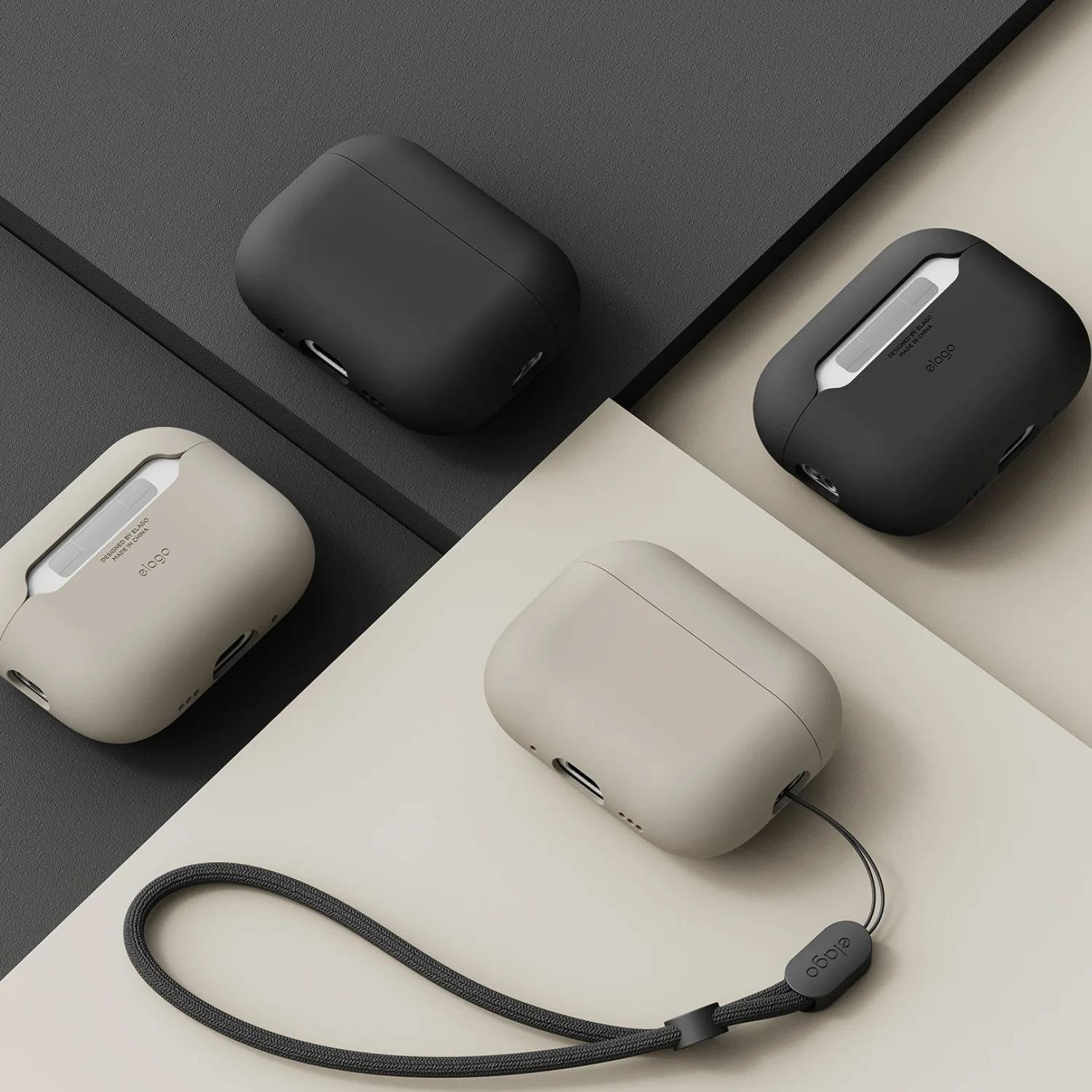 Cztery etui Elago AirPods Pro w kolorach czarnym i beżowym, jedno z paskiem na nadgarstek.
