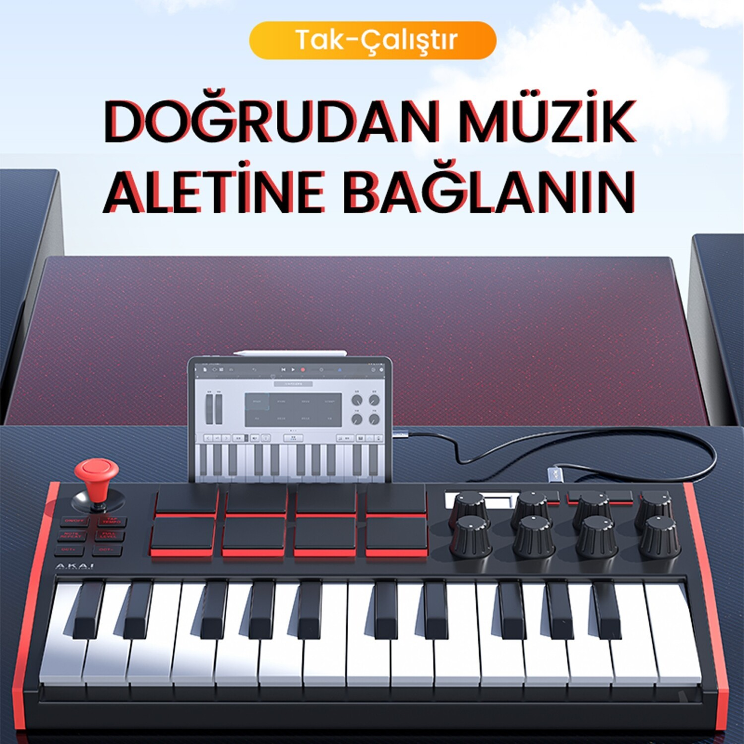 Kırmızı pedleri ve tuşları olan siyah MIDI kontrol cihazı, müzik yazılımı gösteren bir tablete bağlı.