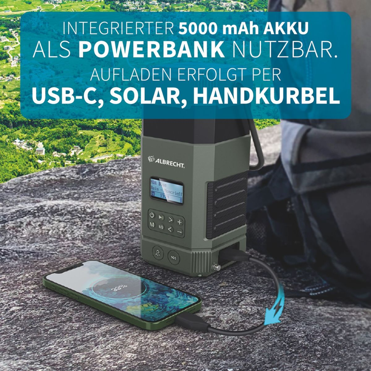 Grüne Powerbank lädt ein Smartphone auf Fels. Text: Integrierter 5000 mAh Akku.
