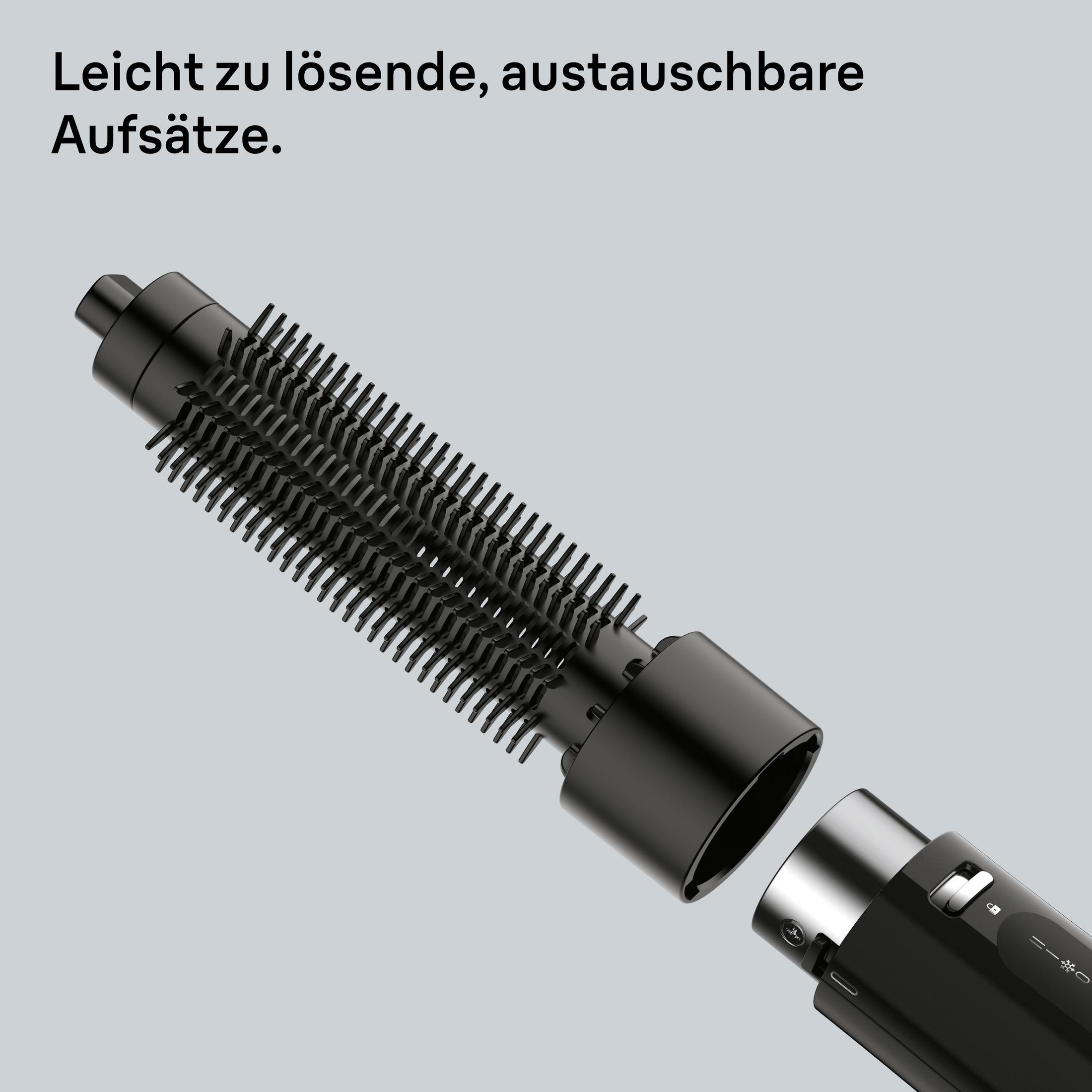 Ein schwarzer Haartrockneraufsatz mit Borsten, der sich von einem Hauptgerät löst.
