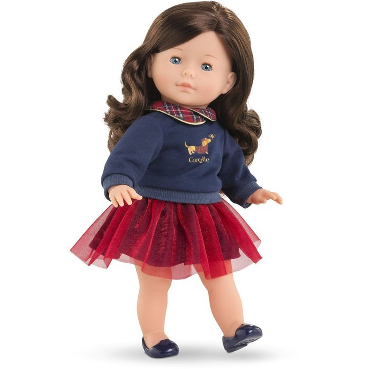 Ein Mädchenpuppe mit braunen Haaren, blauem Pullover mit Hundemotiv und rotem Tüllrock.