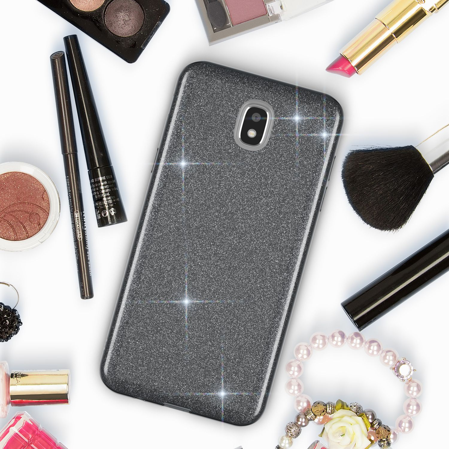 Graue Handyhülle mit Glitzer, umgeben von Make-up und Schmuck.