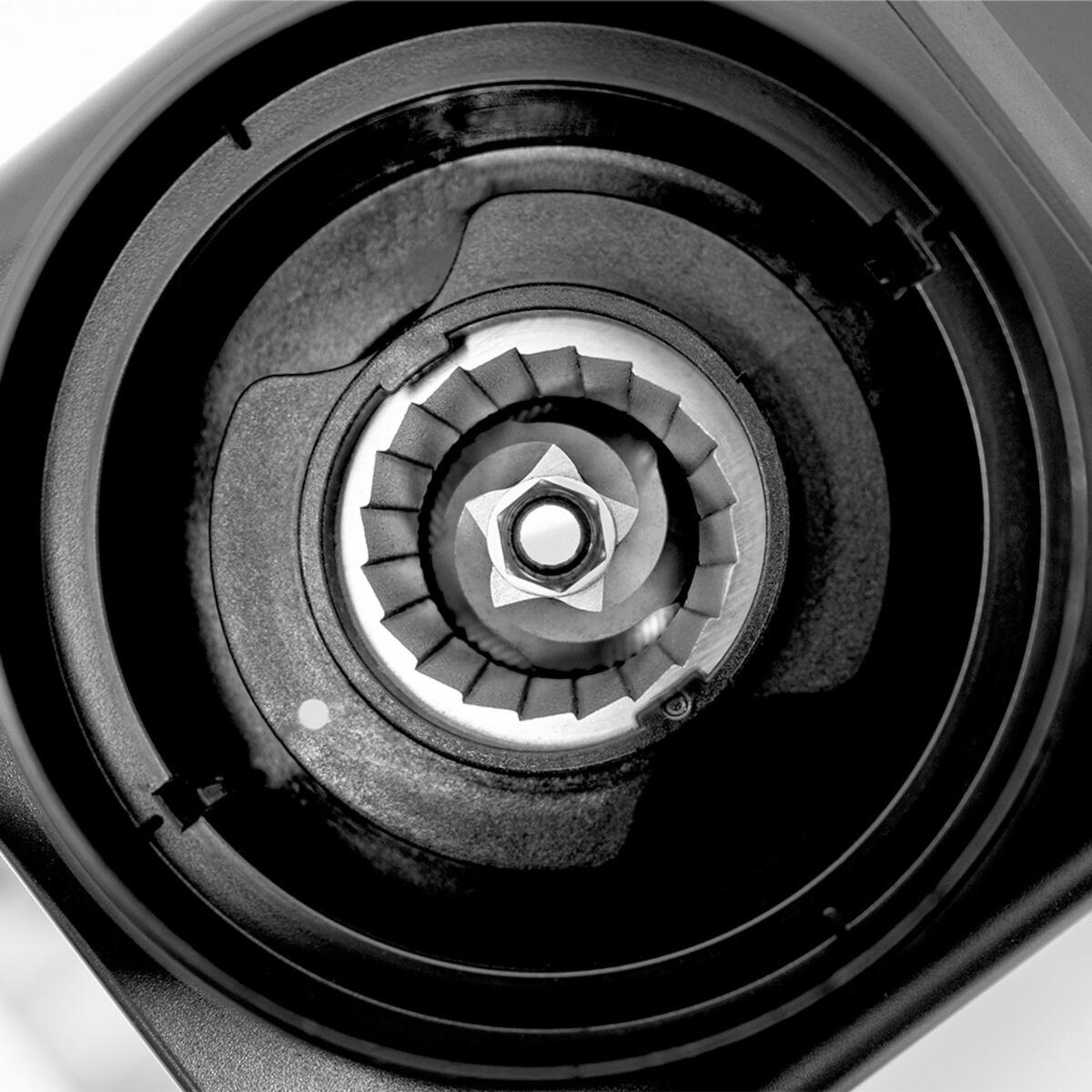 Zbliżenie mechanizmu młynka z zębatymi ostrzami i centralnym detale śruby w kształcie gwiazdy.