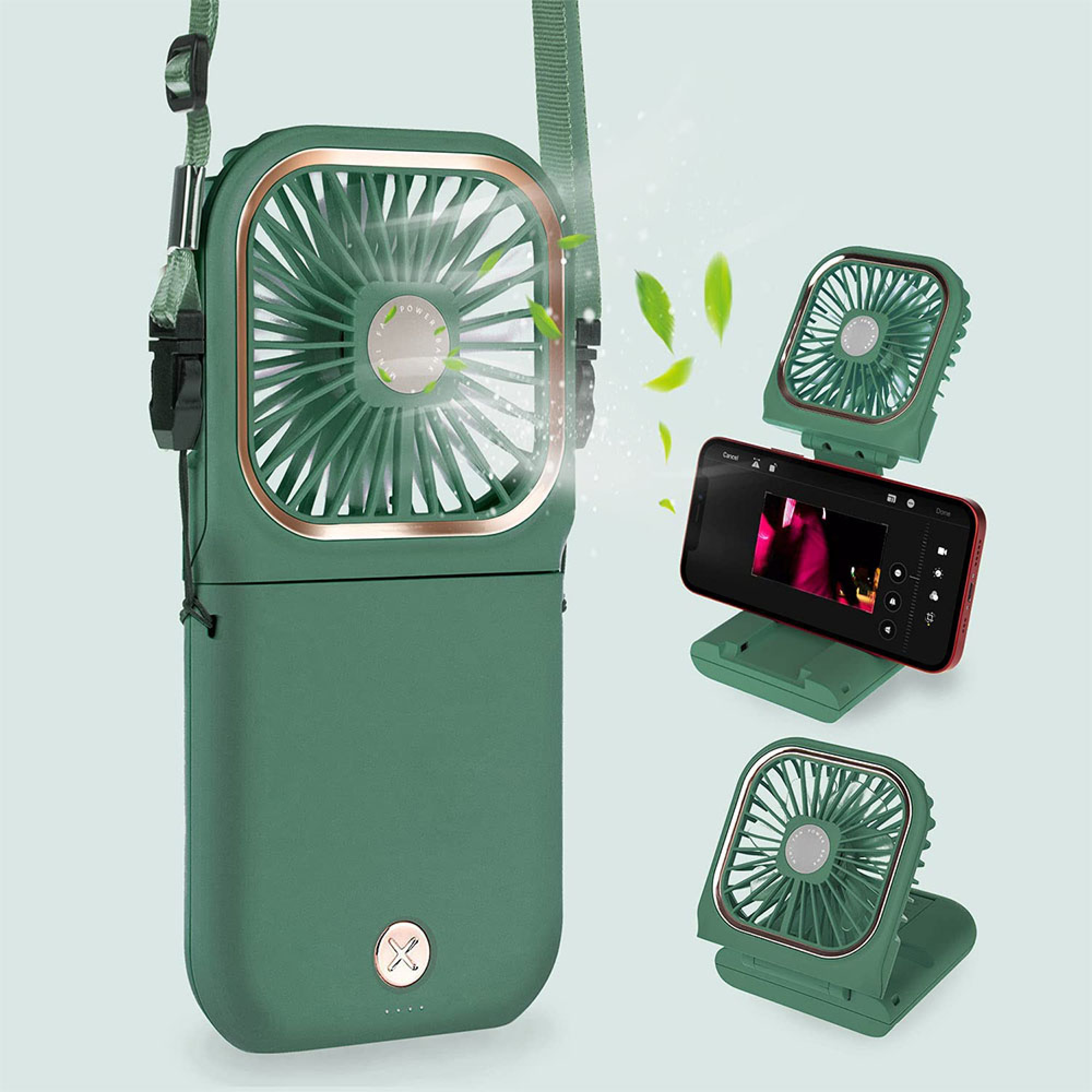 Ein grüner Handventilator mit Tragegurt und ein Handy auf einem Ständer.