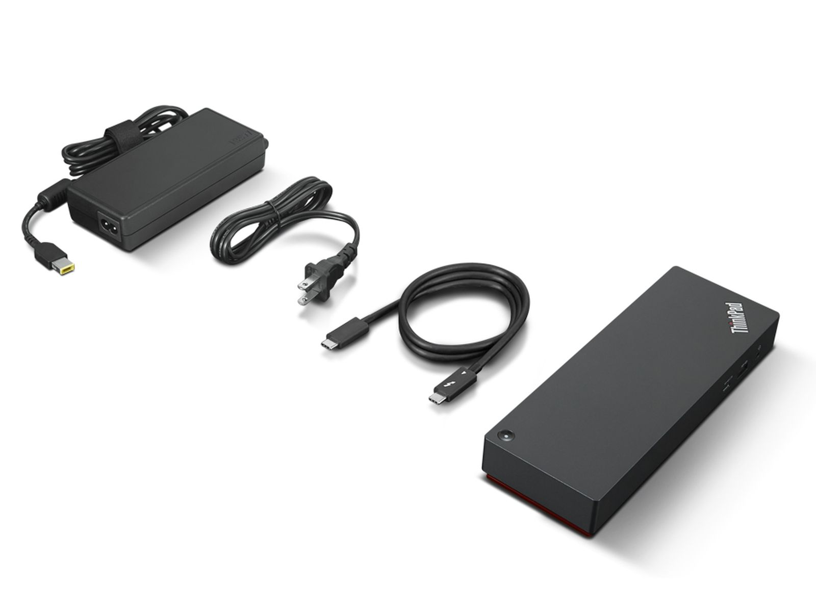 Alimentatore nero con cavi e docking station, su sfondo bianco.