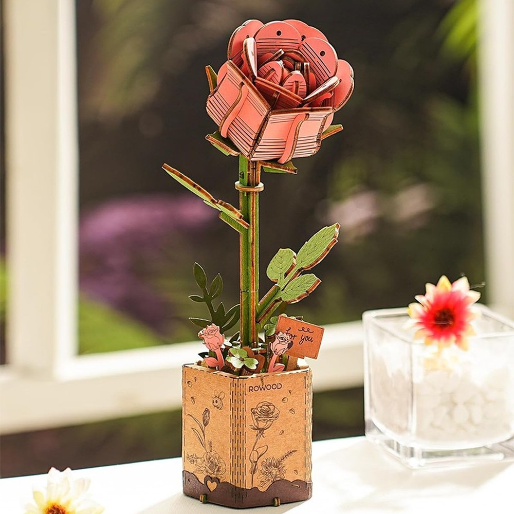 Un modelo de rosa de madera en una maceta con la etiqueta "ROWOOD".
