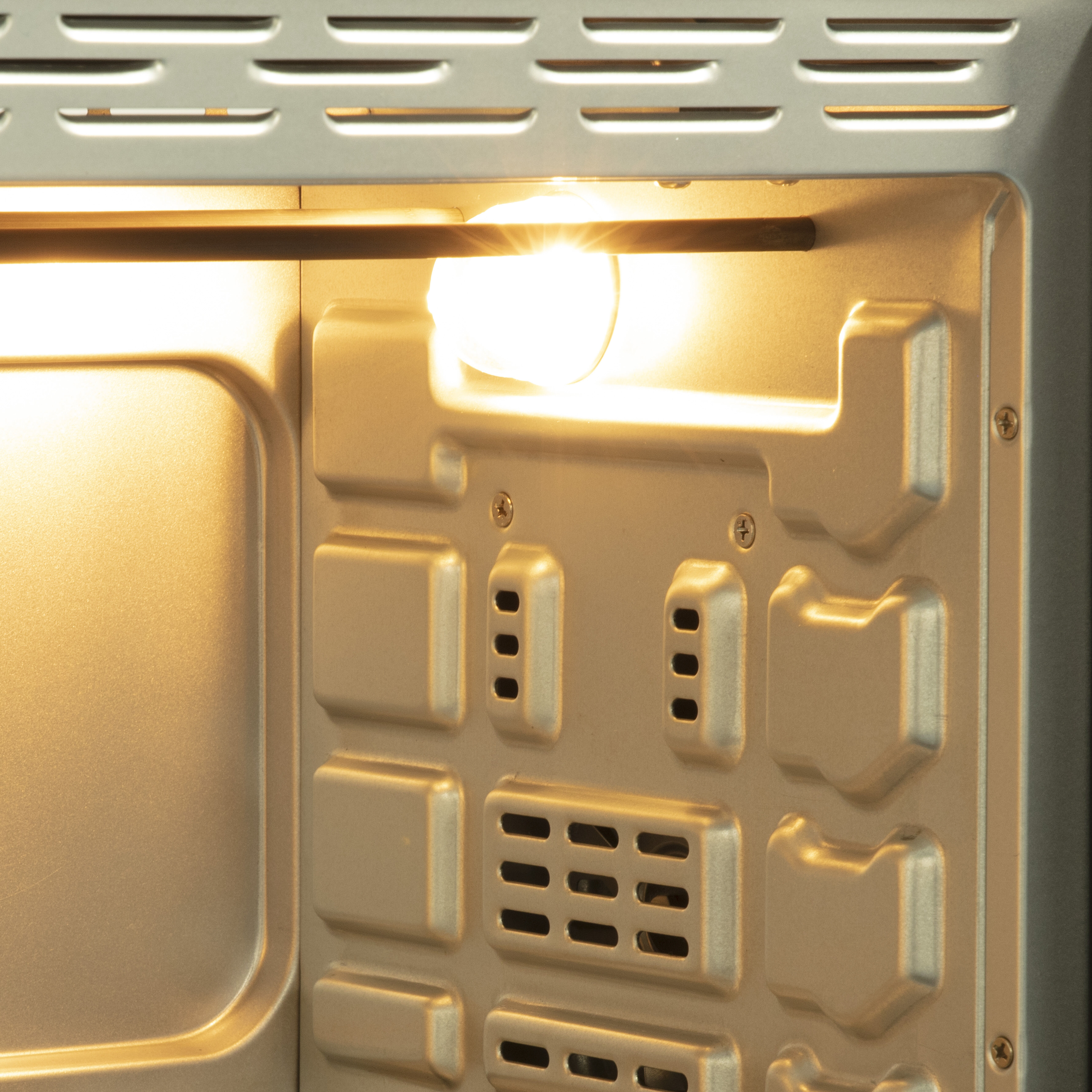 Close-up of a toaster interior with the light on.