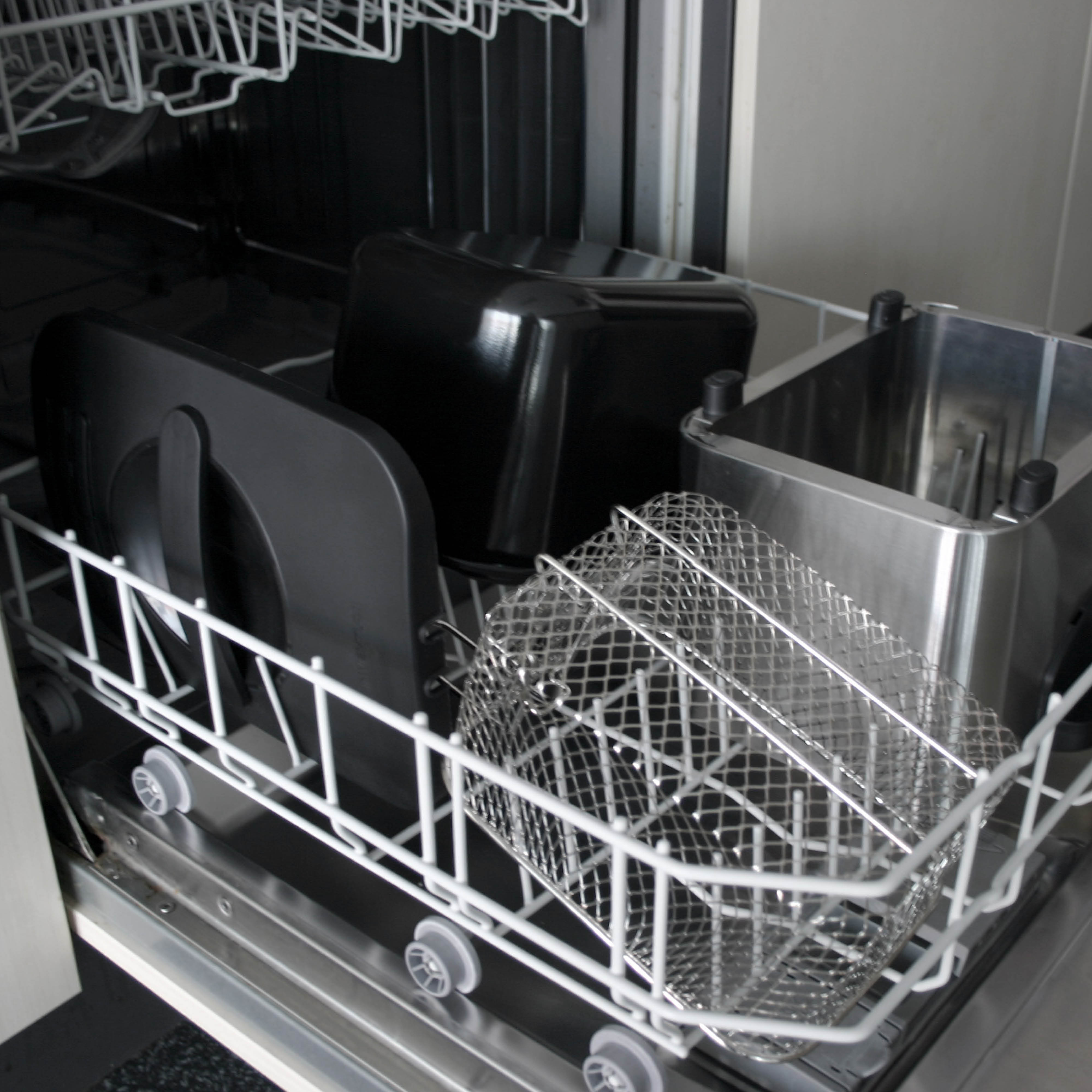 Built-in dishwasher with two racks, a black insert, and a metal basket.