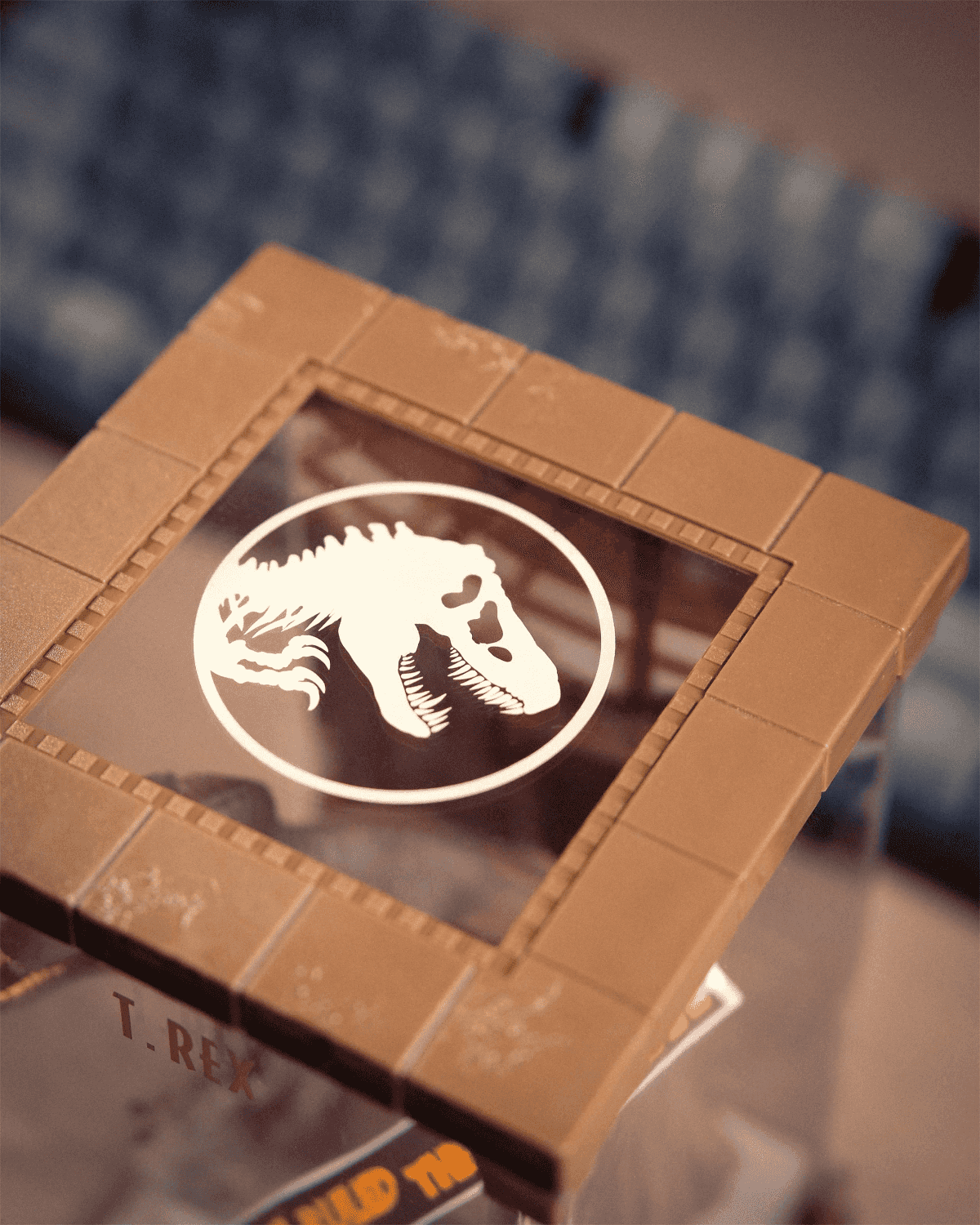 Un objeto de marco marrón con un logo blanco de T-Rex.