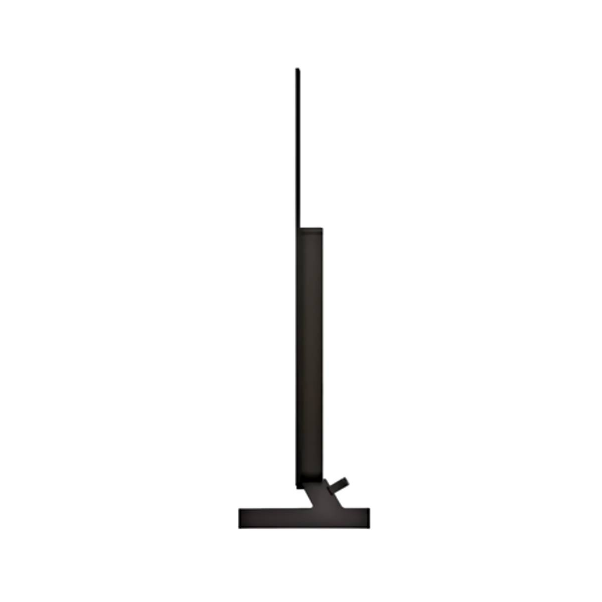Un televisor negro con un soporte delgado, visto de lado.