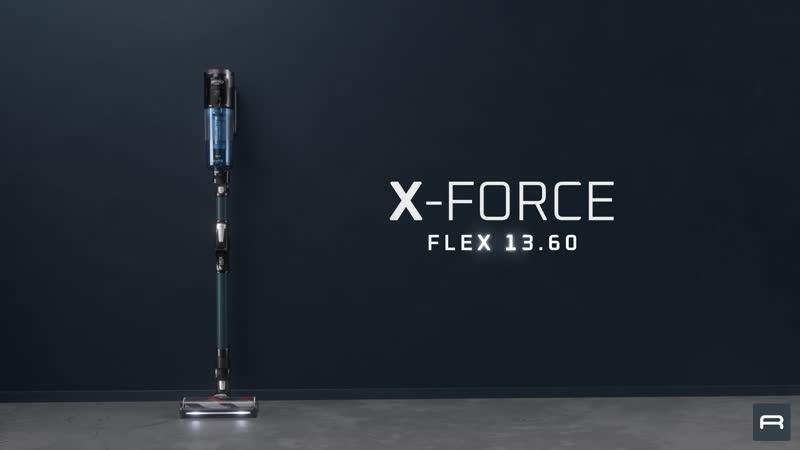 Un aspirapolvere moderno e senza fili con contenitore blu si trova su un pavimento in cemento.