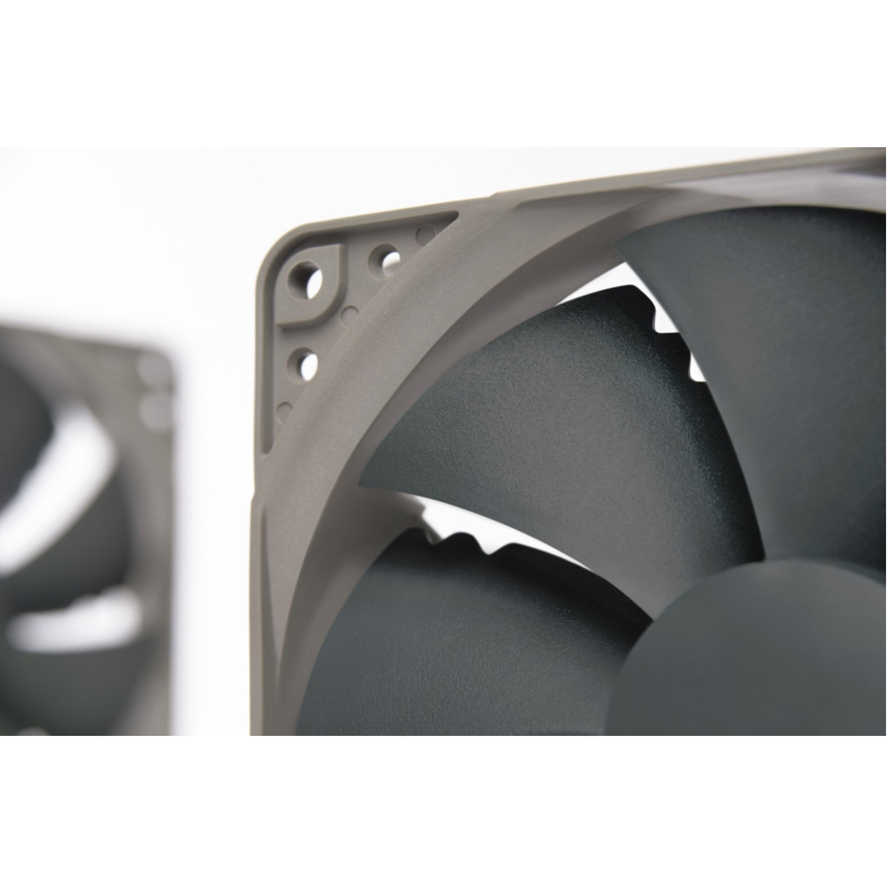 Close-up of a grey fan frame with dark blades, white background.