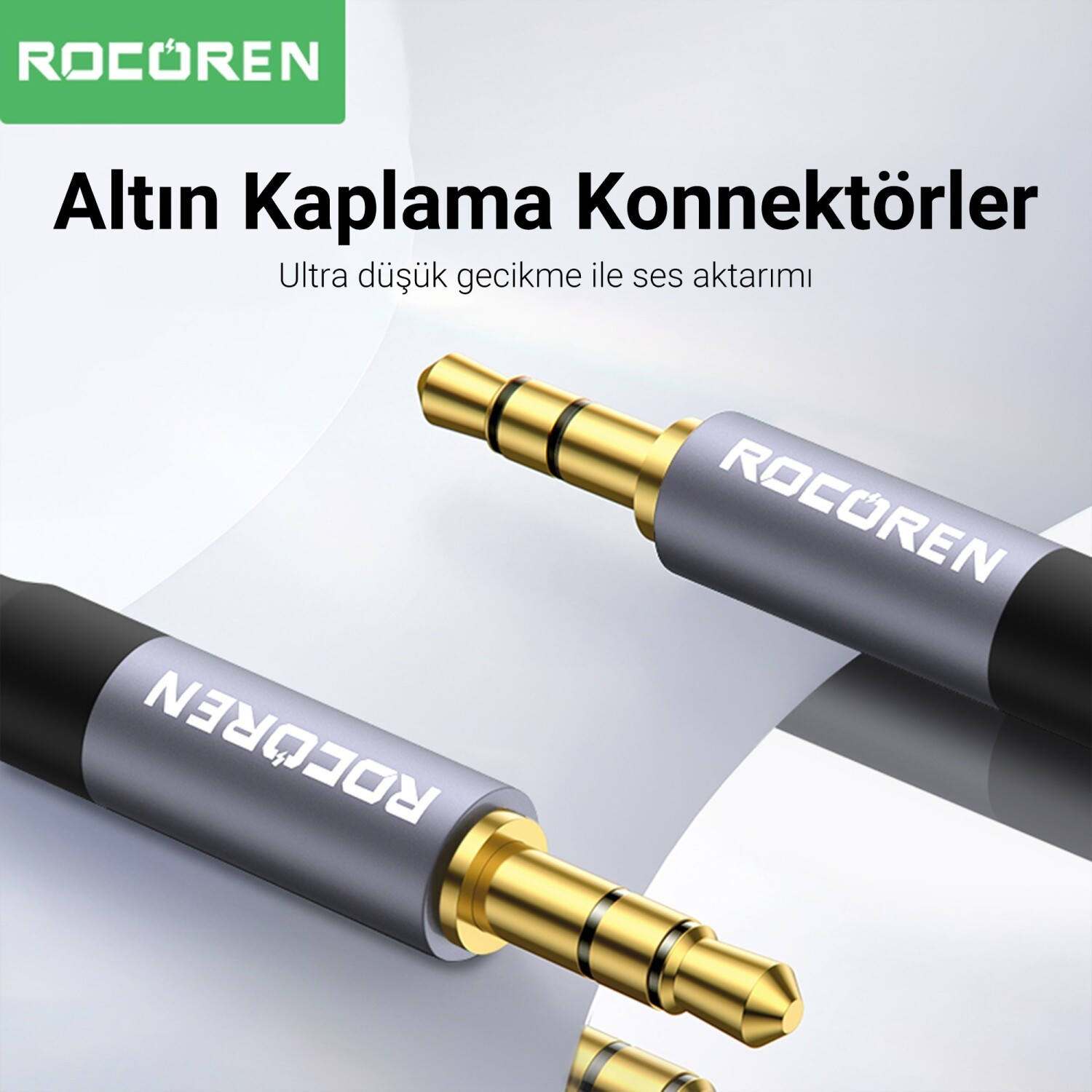 Gri arka plan üzerinde ROCOREN logolu iki altın kaplama 3,5 mm ses konektörü.