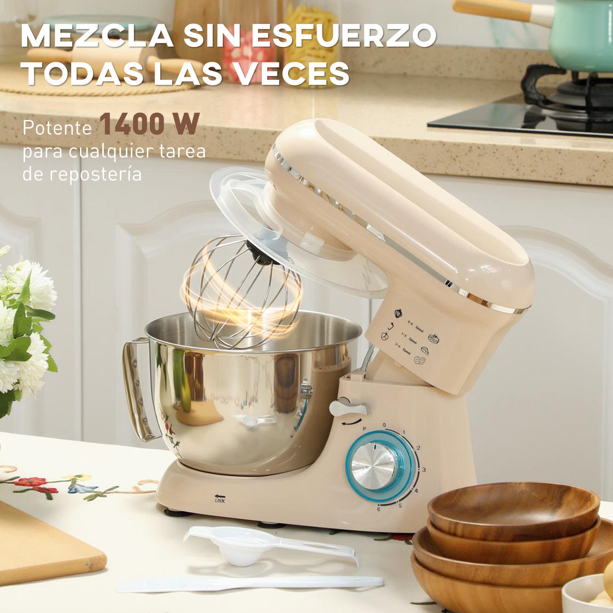 Una batidora de pie color crema con bol de acero inoxidable sobre una mesa.