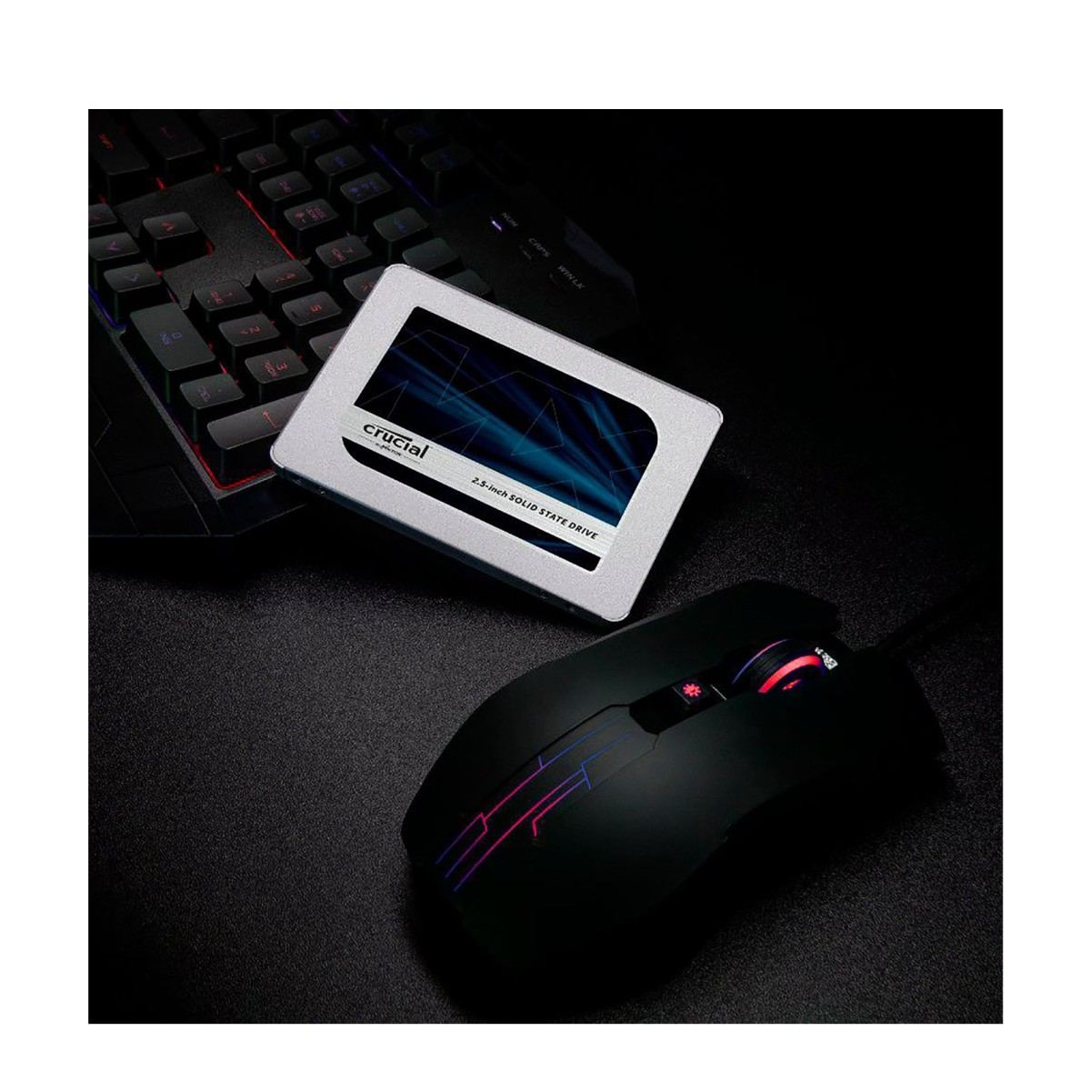 An SSD, gaming mouse, and keyboard are on a dark surface.