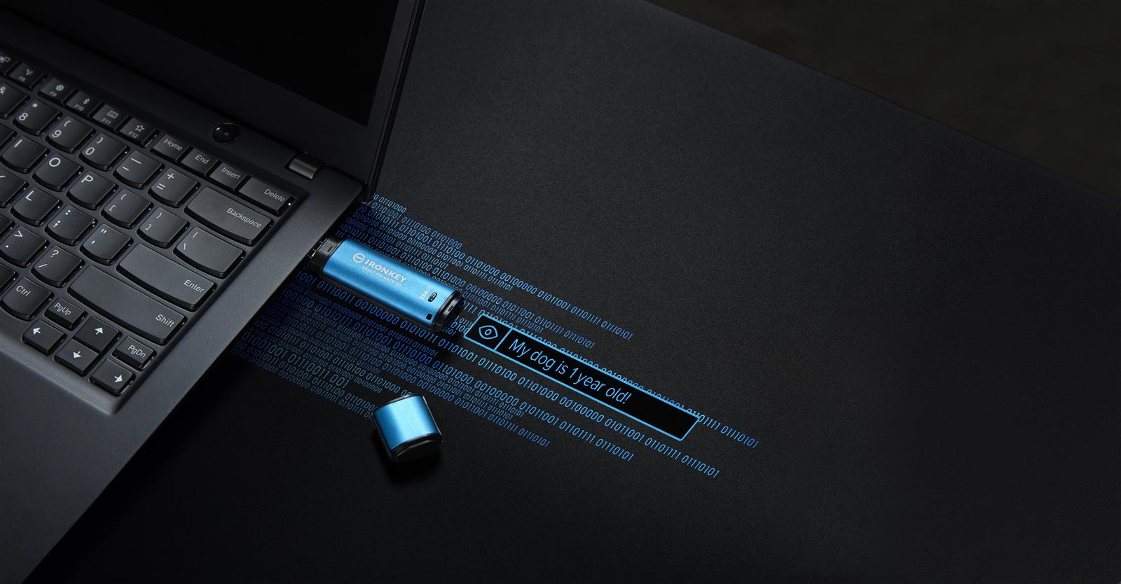 Un'unità USB blu inserita in un laptop con codice binario.
