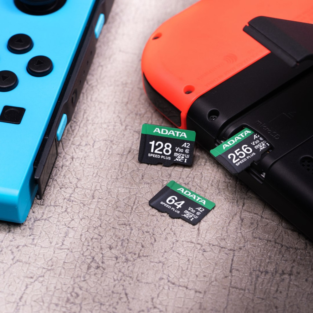 Trzy karty microSD ADATA obok konsoli Nintendo Switch.