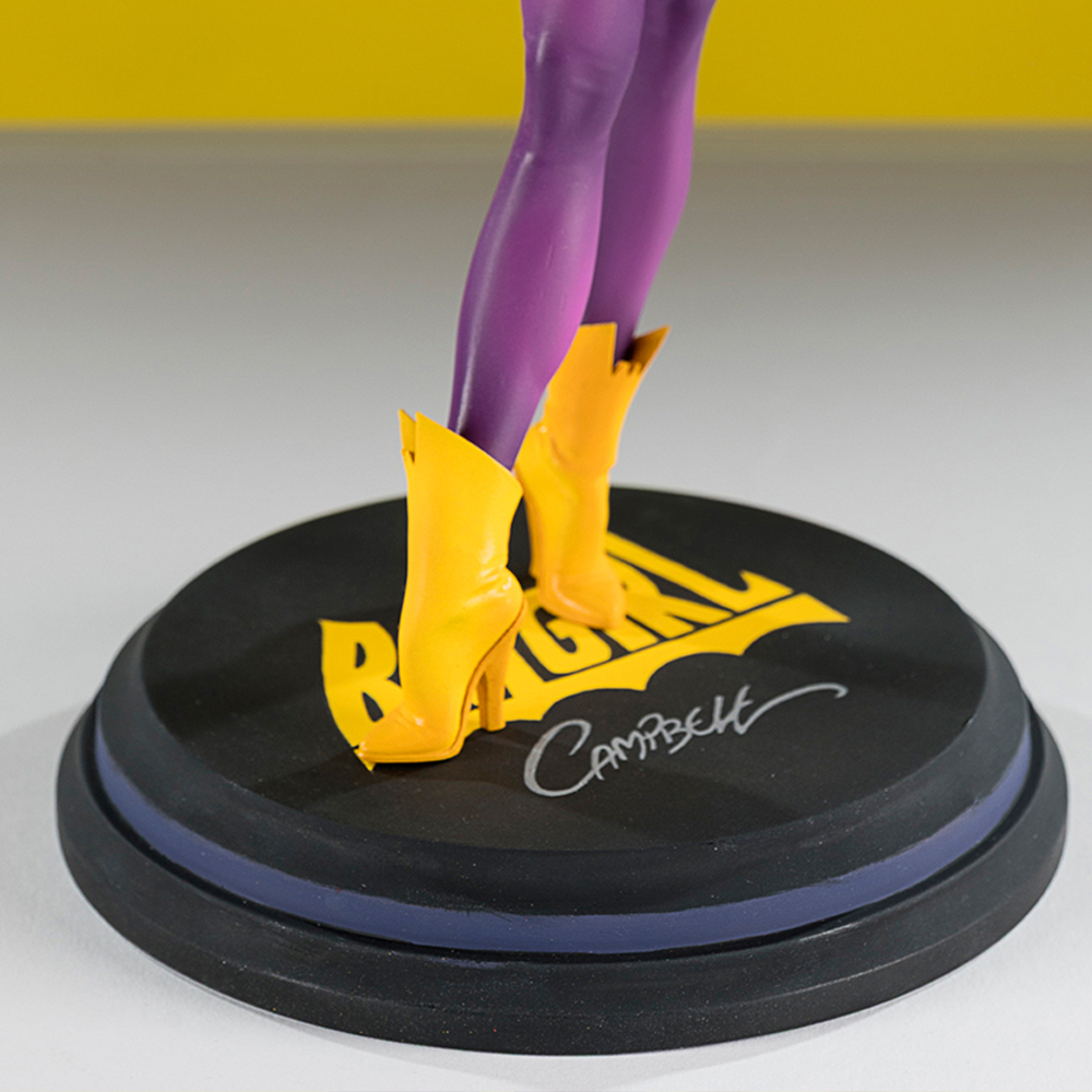 Una figura con calze viola e stivali gialli su una base nera.