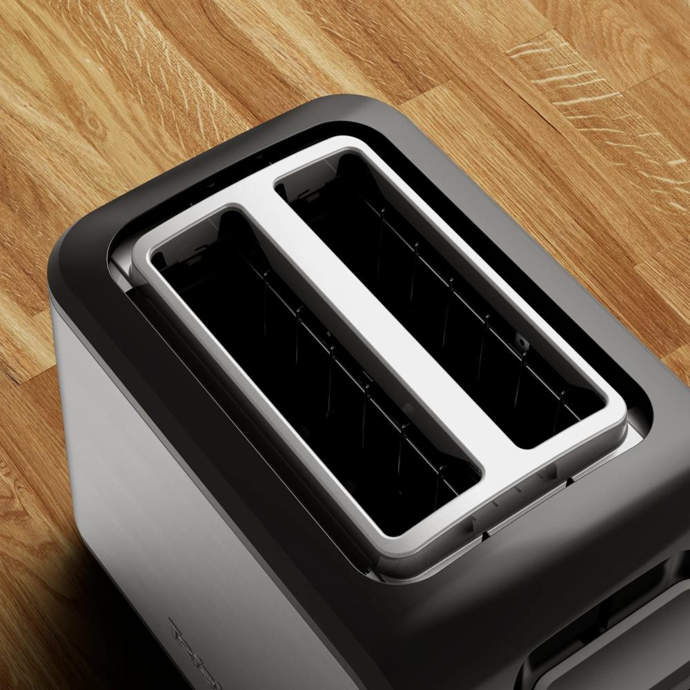 A modern two-slot toaster sits on a wooden floor.