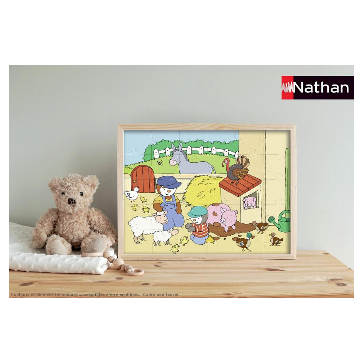 Bauernhof-Puzzle mit Tieren, Kindern und einem Teddybär daneben.