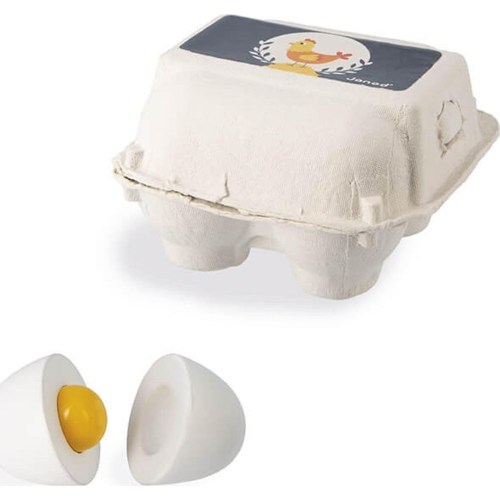 Un cartón de huevos blanco con ilustración de pollo y dos huevos de juguete partidos.