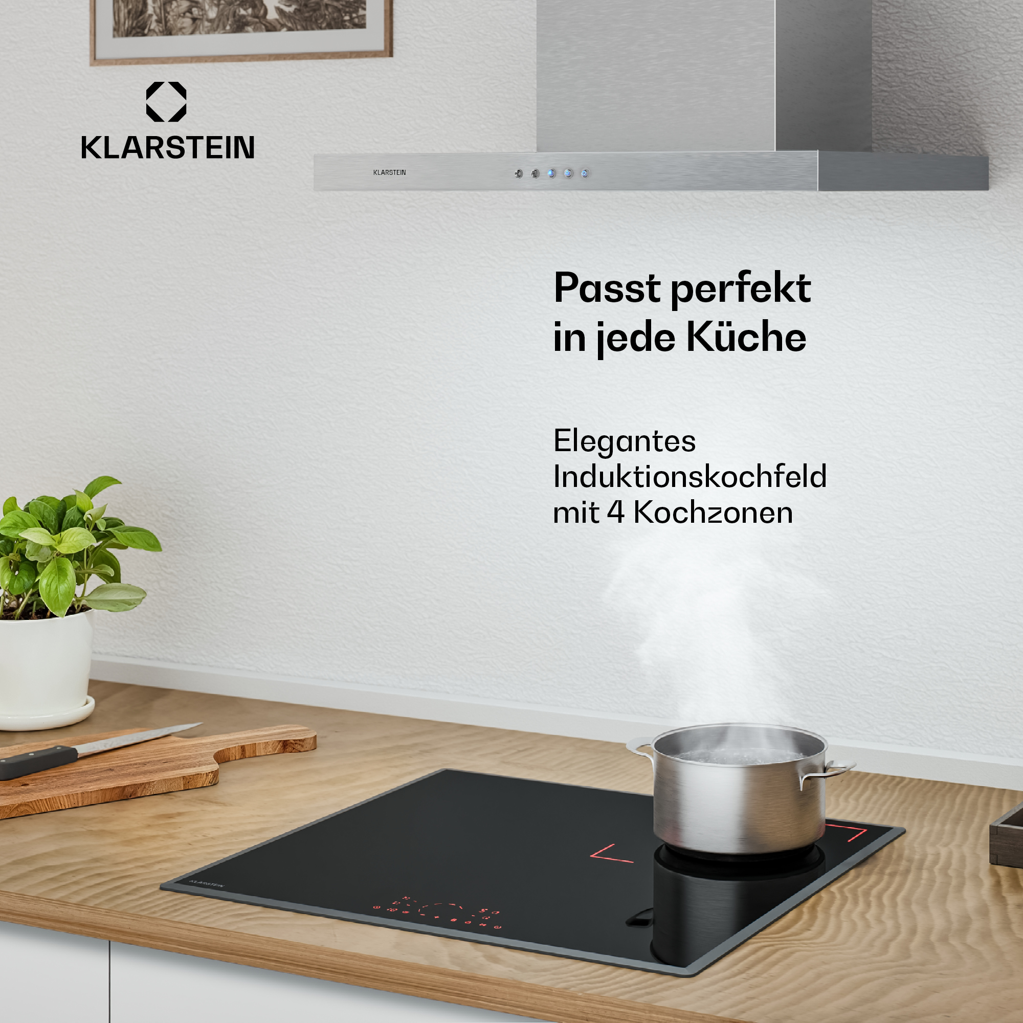 Ein silberner Topf kocht auf einem schwarzen Induktionskochfeld mit vier Kochzonen.