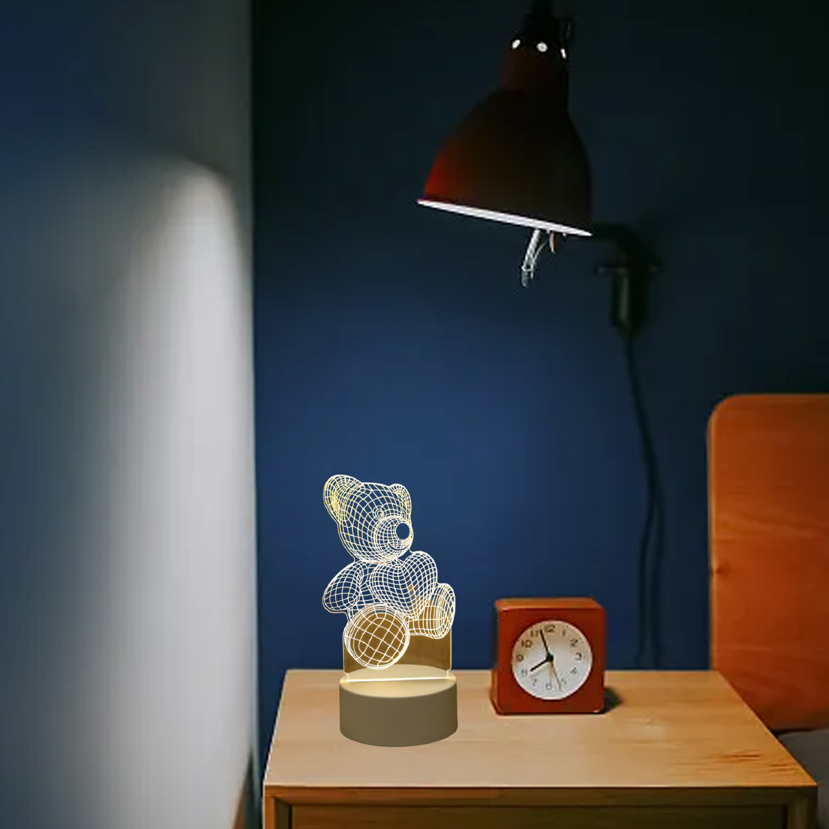 Ein Teddybär-Nachtlicht leuchtet auf einem Nachttisch neben einem roten Wecker.