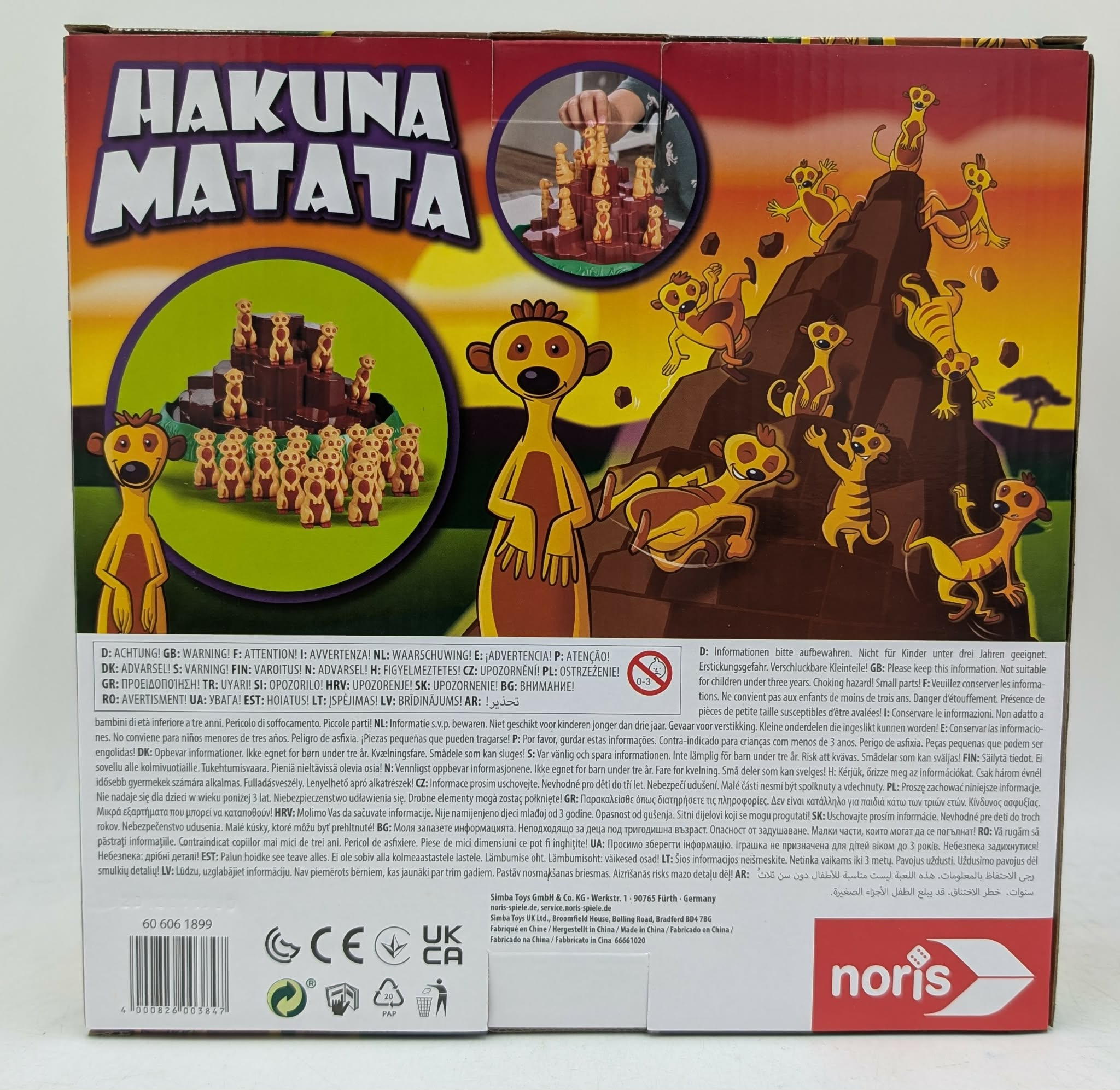 Hakuna Matata Brettspiel-Box mit detailreichen Illustrationen von Erdmännchen auf einem Felsen.
