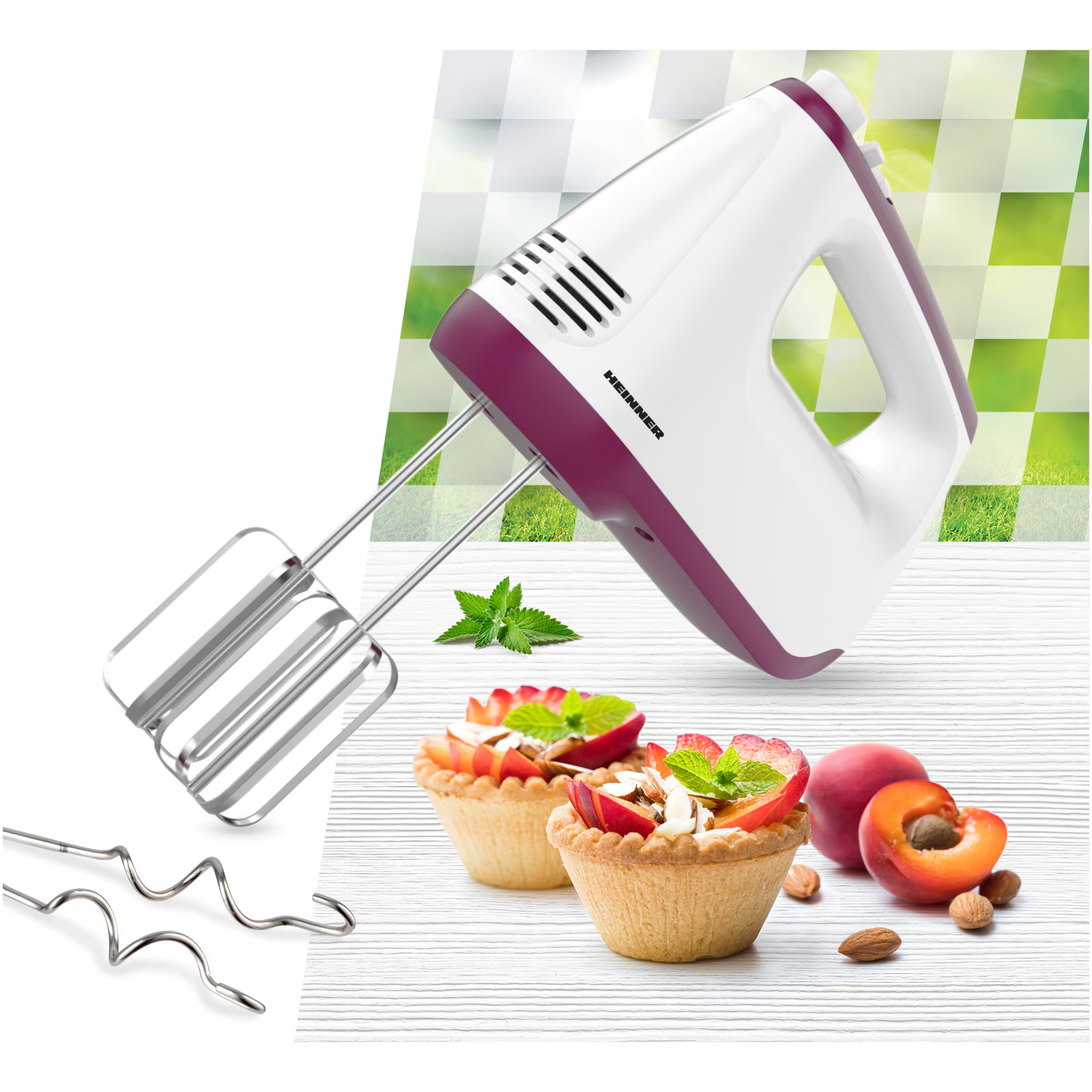 A hand mixer with purple accents sits beside fruit tarts and fruits.