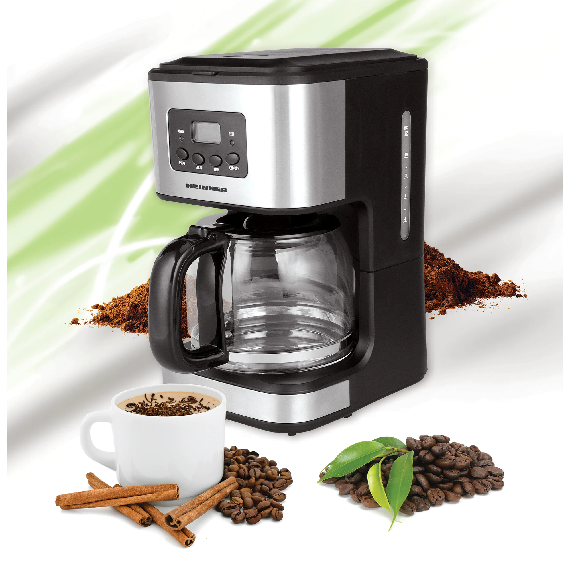 Cafetière avec verseuse en verre, tasse à café, grains de café et bâtons de cannelle.