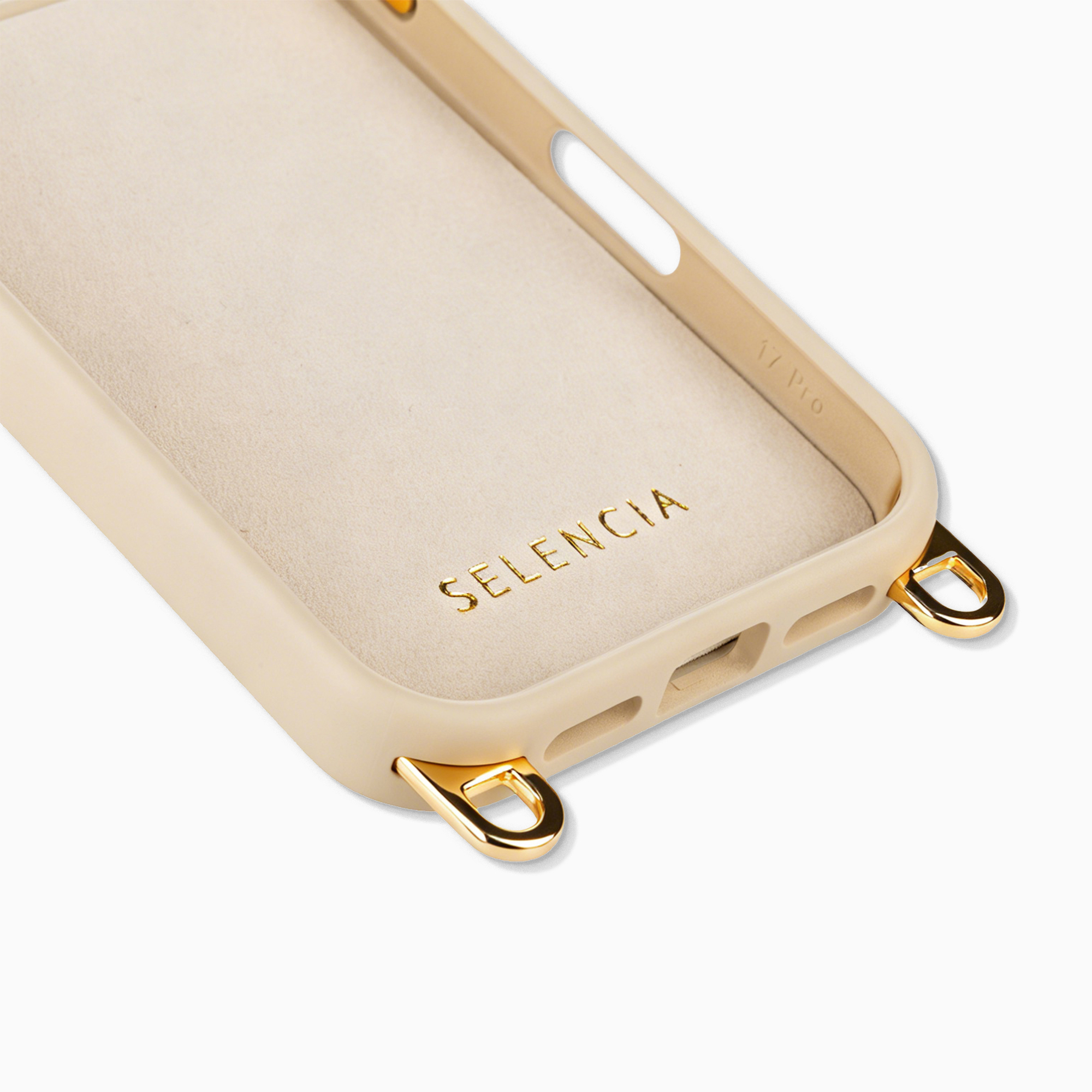 Een beige telefoonhoesje met gouden oogjes en merknnaam op witte achtergrond.