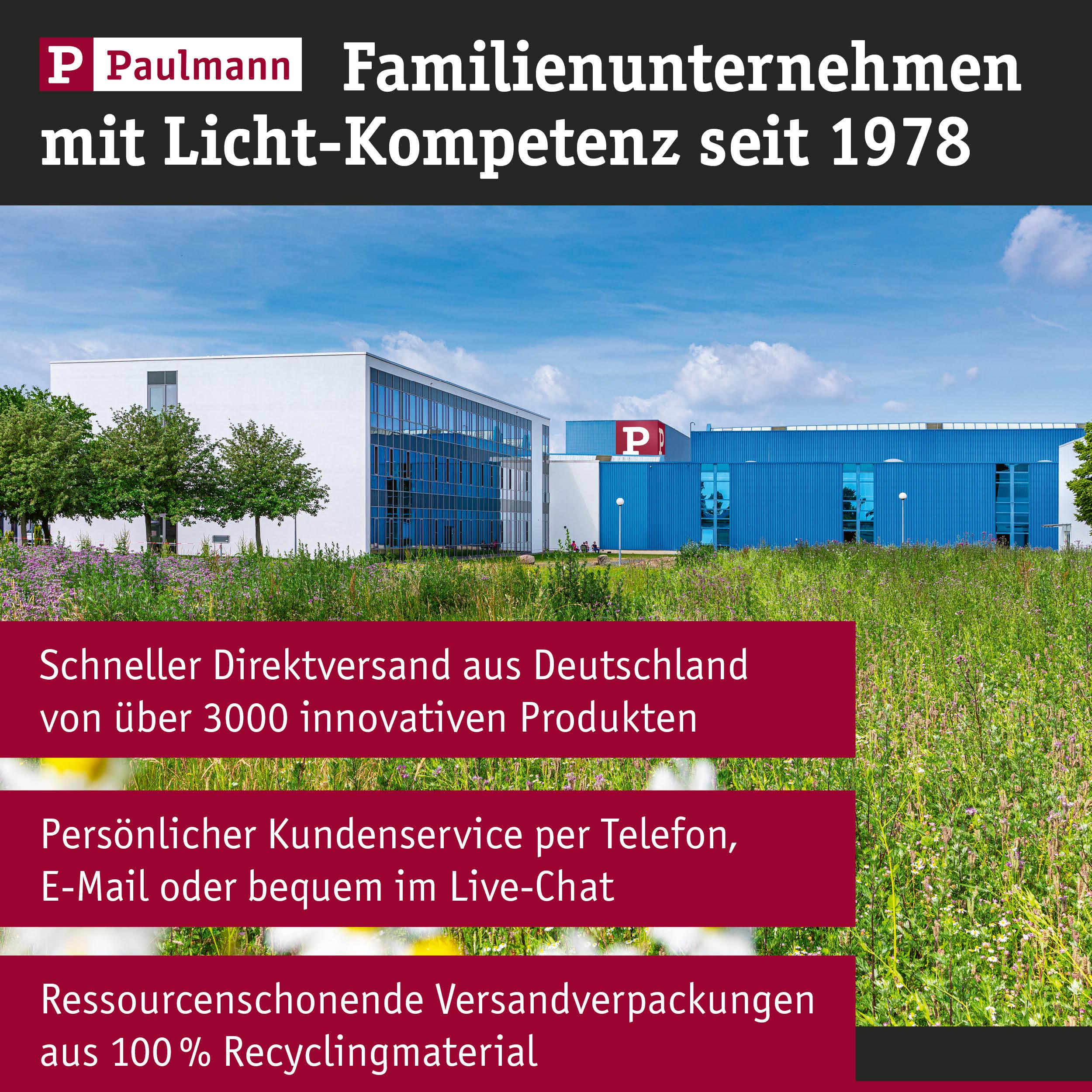 Paulmann Firmengebäude mit blauem und weißem Teil, Wiesen und Textboxen.
