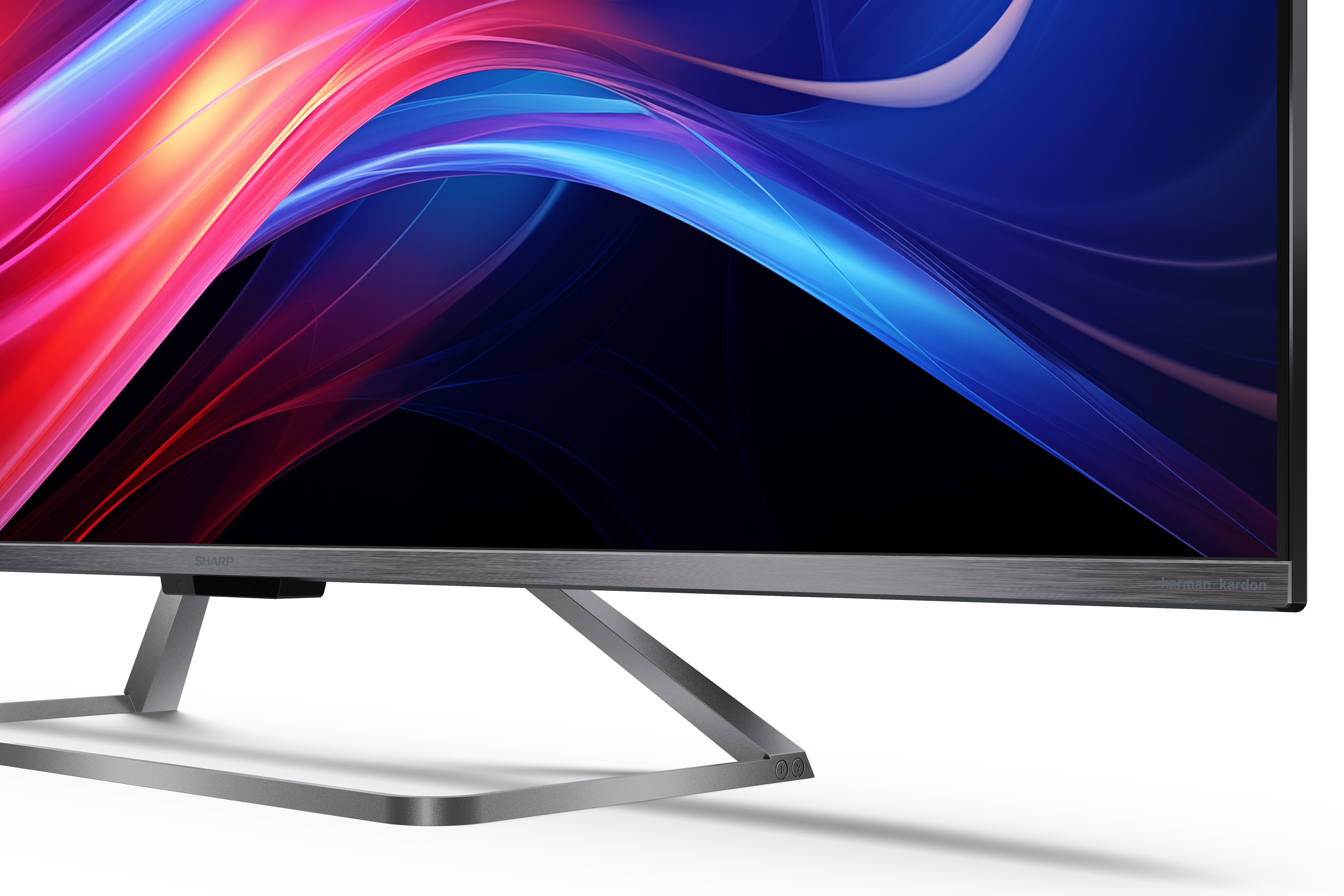 Un monitor che visualizza uno sfondo astratto e colorato di onde rosse, blu e gialle.
