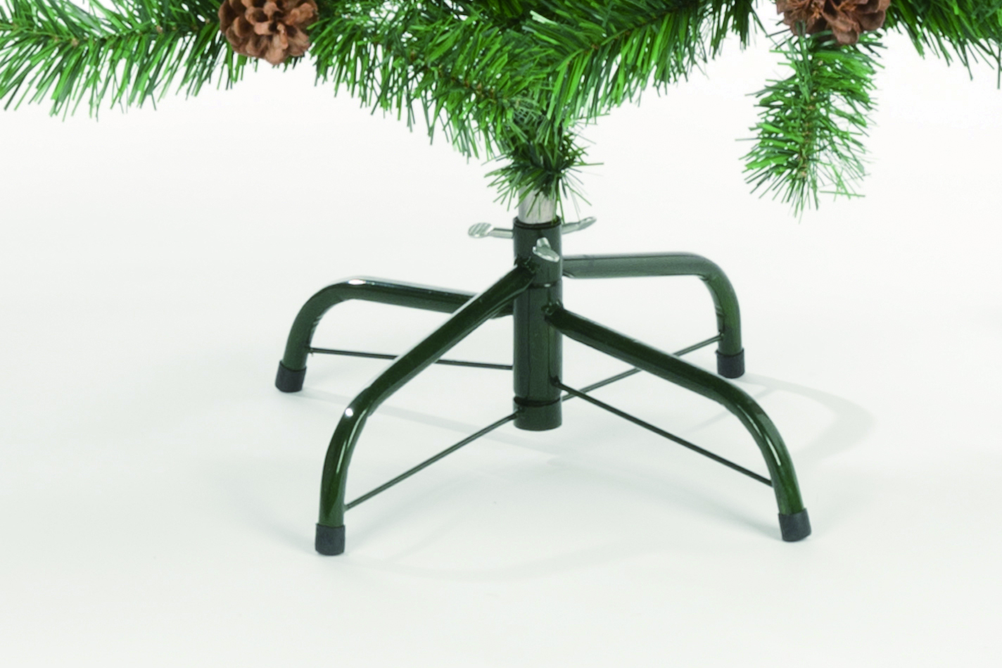 Green Christmas tree stand with pinecones and needles.